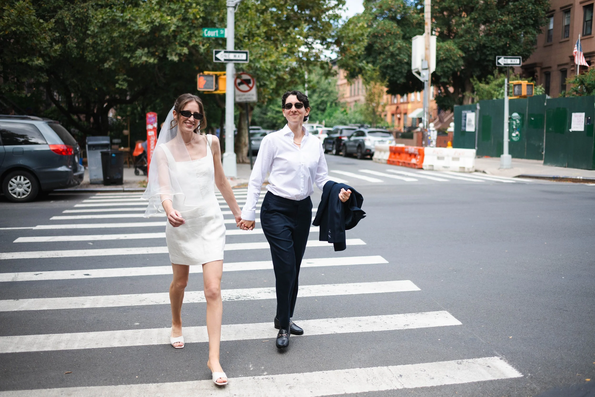 Couple walking through Brooklyn on their way to their Manhattan courthouse wedding