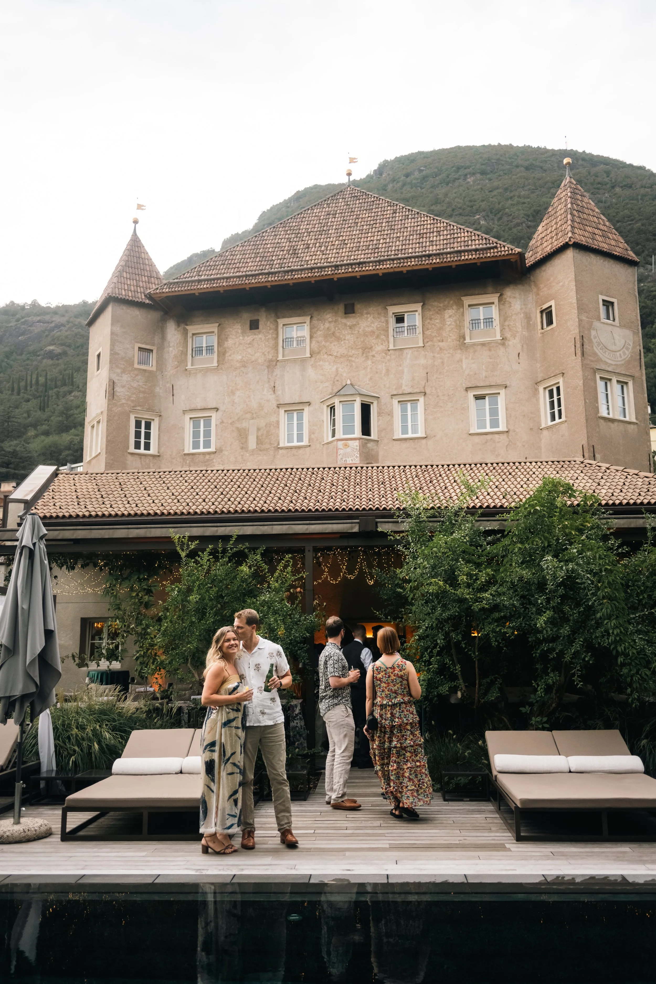  Bride and groom posing outside Castel Hörtenberg in Bolzano, captured by a destination wedding photographer during their pre-wedding celebration. 