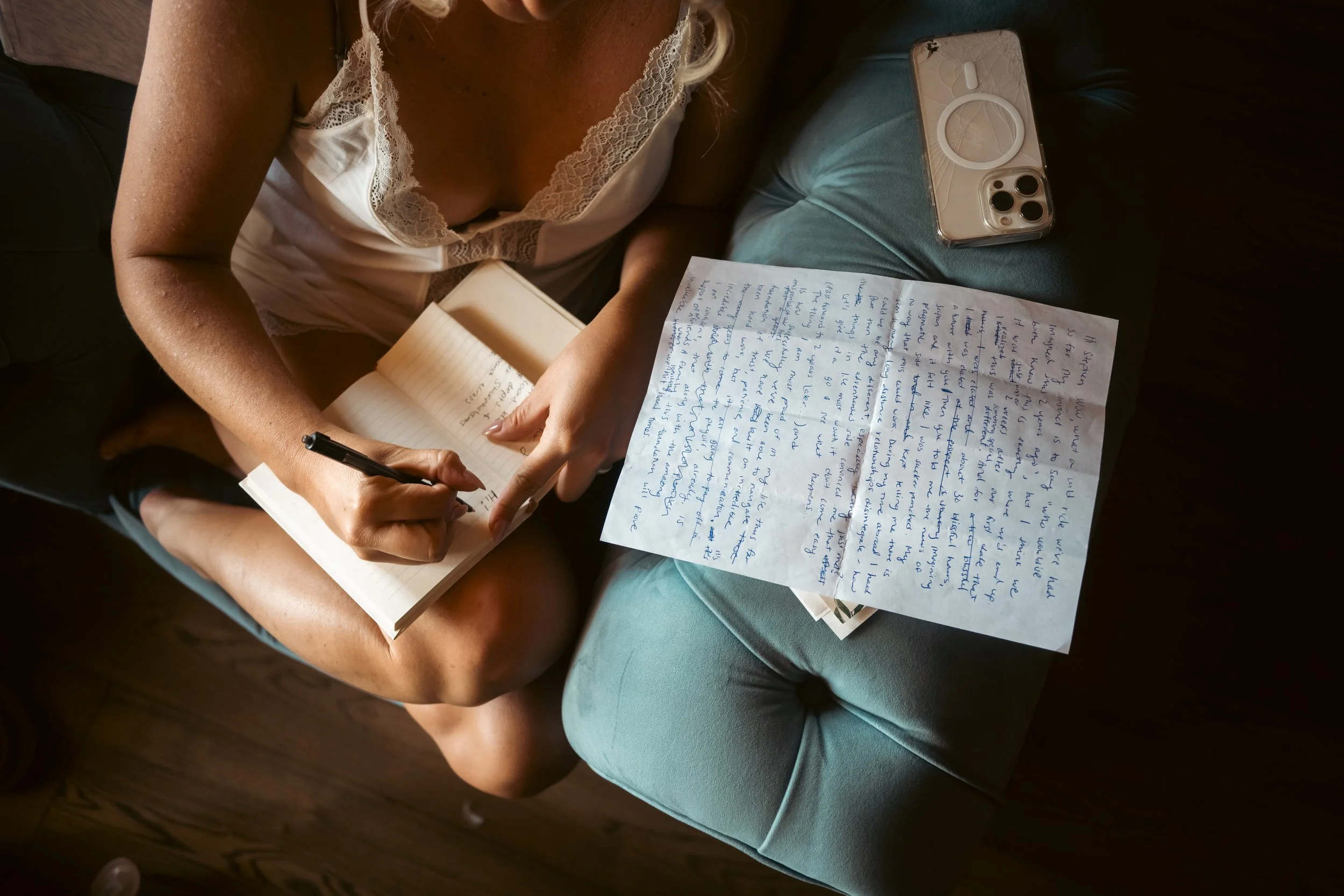  Intimate getting-ready photo of the bride writing her personal wedding vows inside Castel Hörtenberg. 