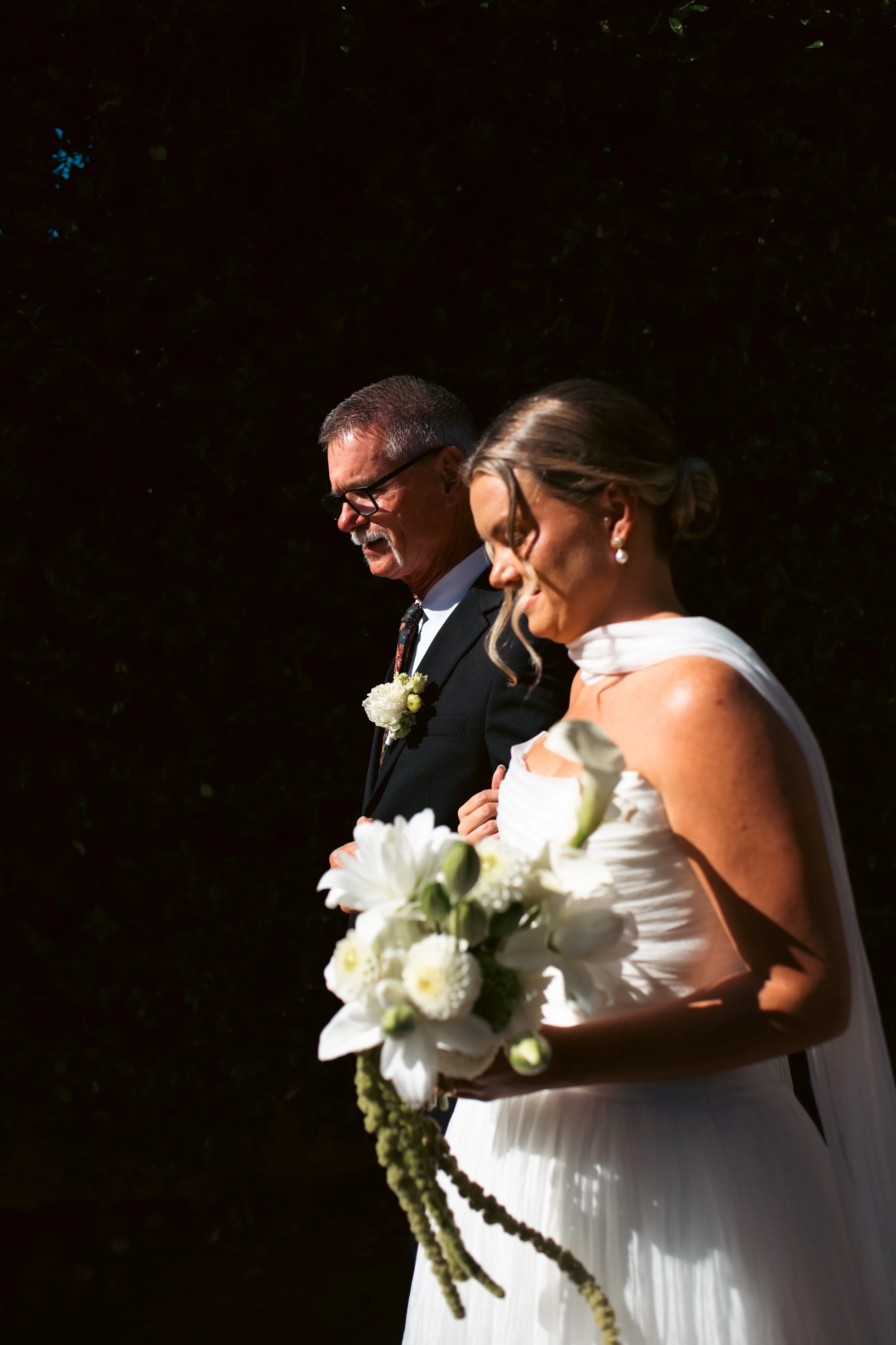  Father of the bride walking his daughter down the outdoor ceremony aisle at Castel Hörtenberg in Bolzano. 
