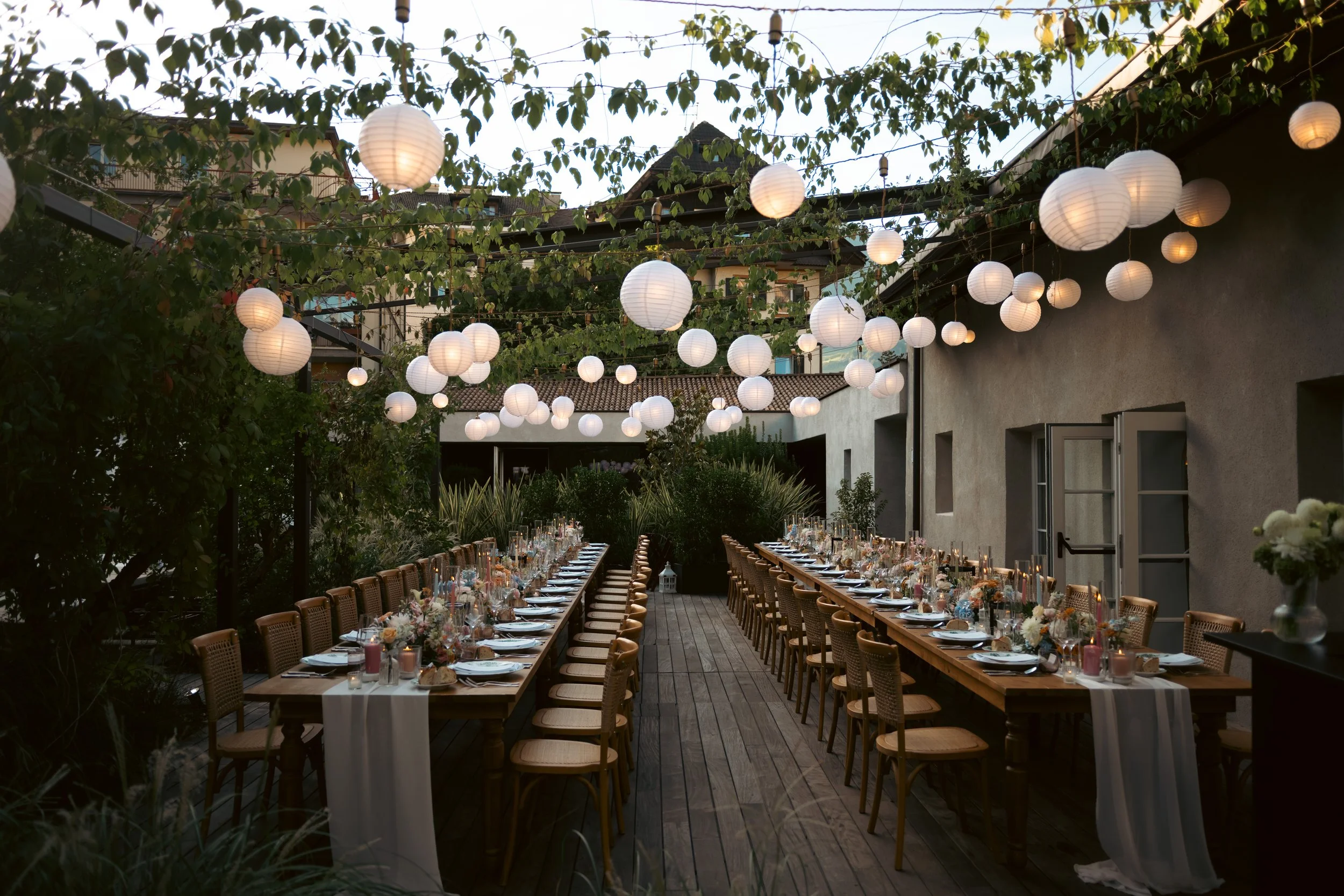  Elegant wedding reception dinner table setting featuring sophisticated florals, candles, and fine dining tableware. 