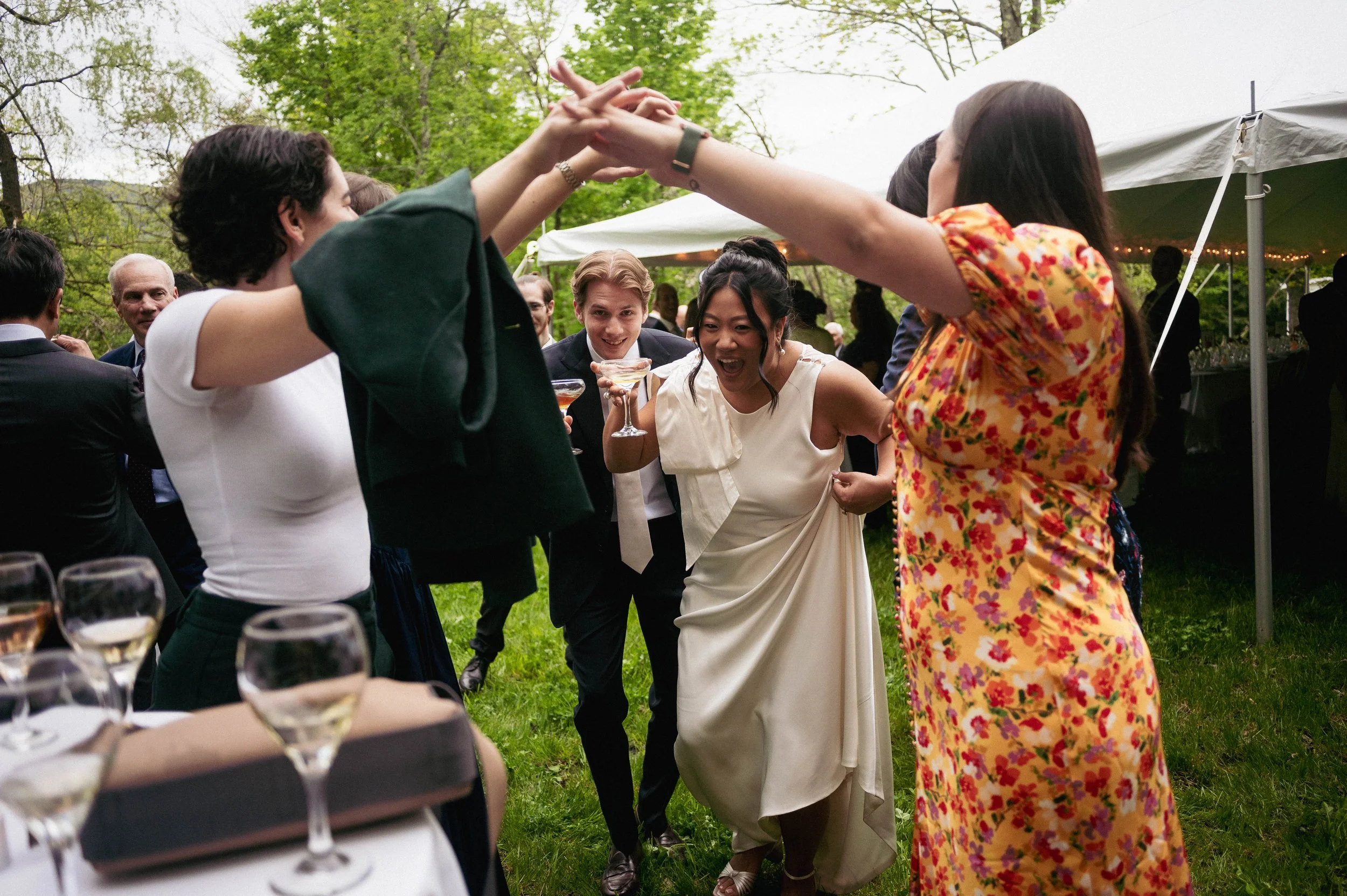 Bride and groom running through an arch created by their guests at an upstate New York wedding