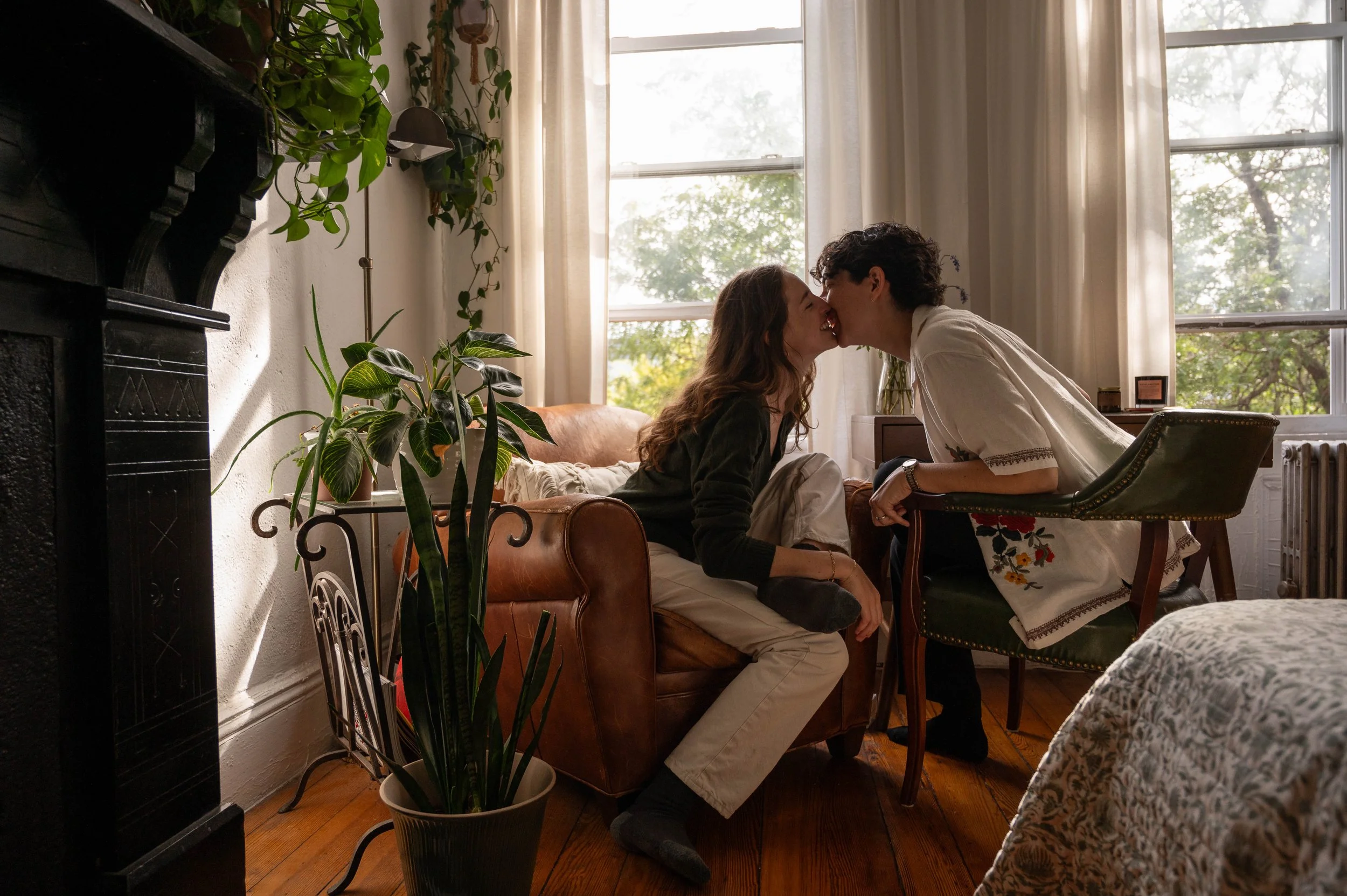 Queer couple kissing in their Brooklyn apartment during an at-home 