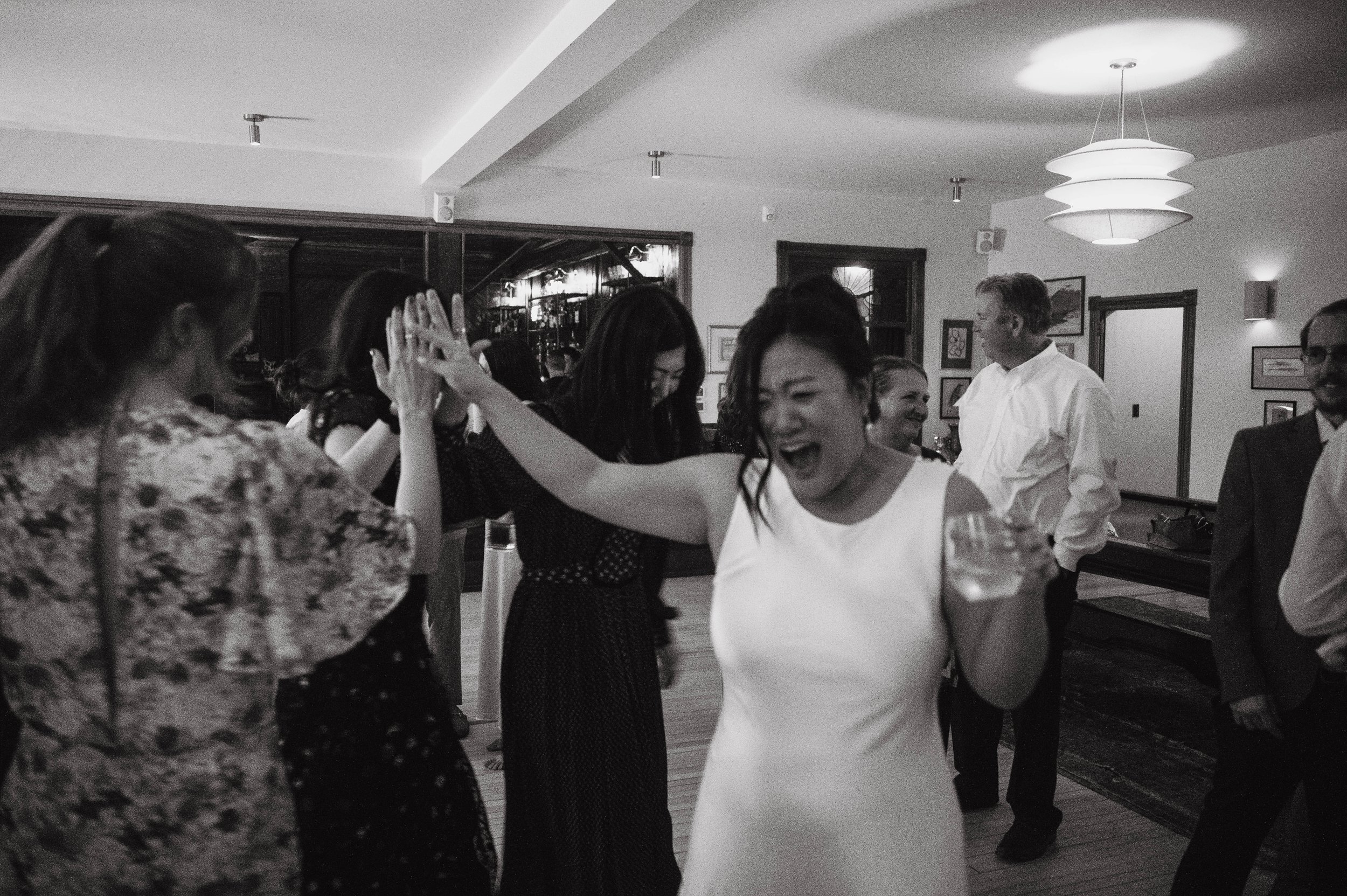 Bride dancing with friends during an upstate New York wedding reception