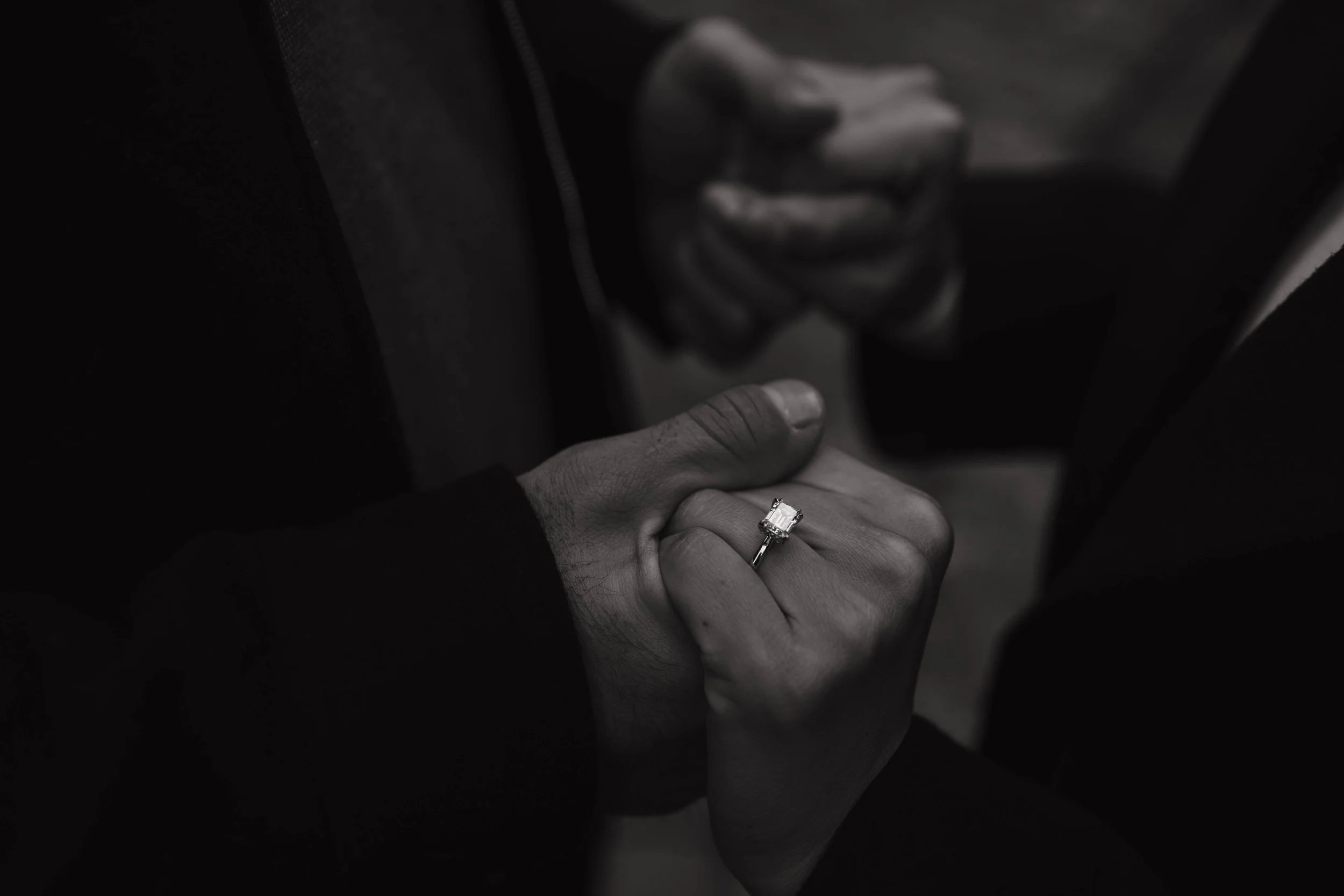 Detail shot of a couple's hands showing off an engagement ring in SoHo New York City
