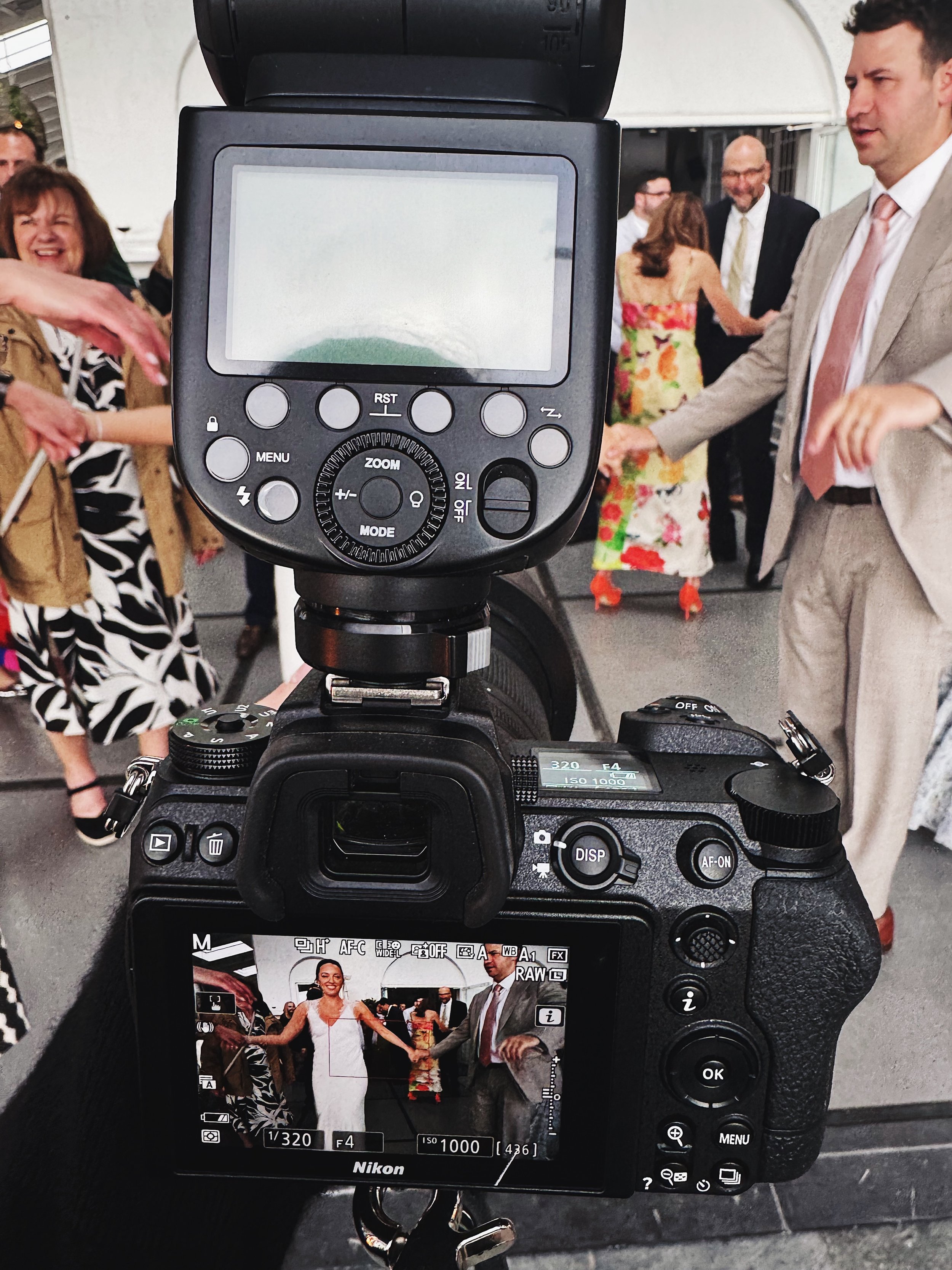 Image of the back of a photographer's camera at a wedding
