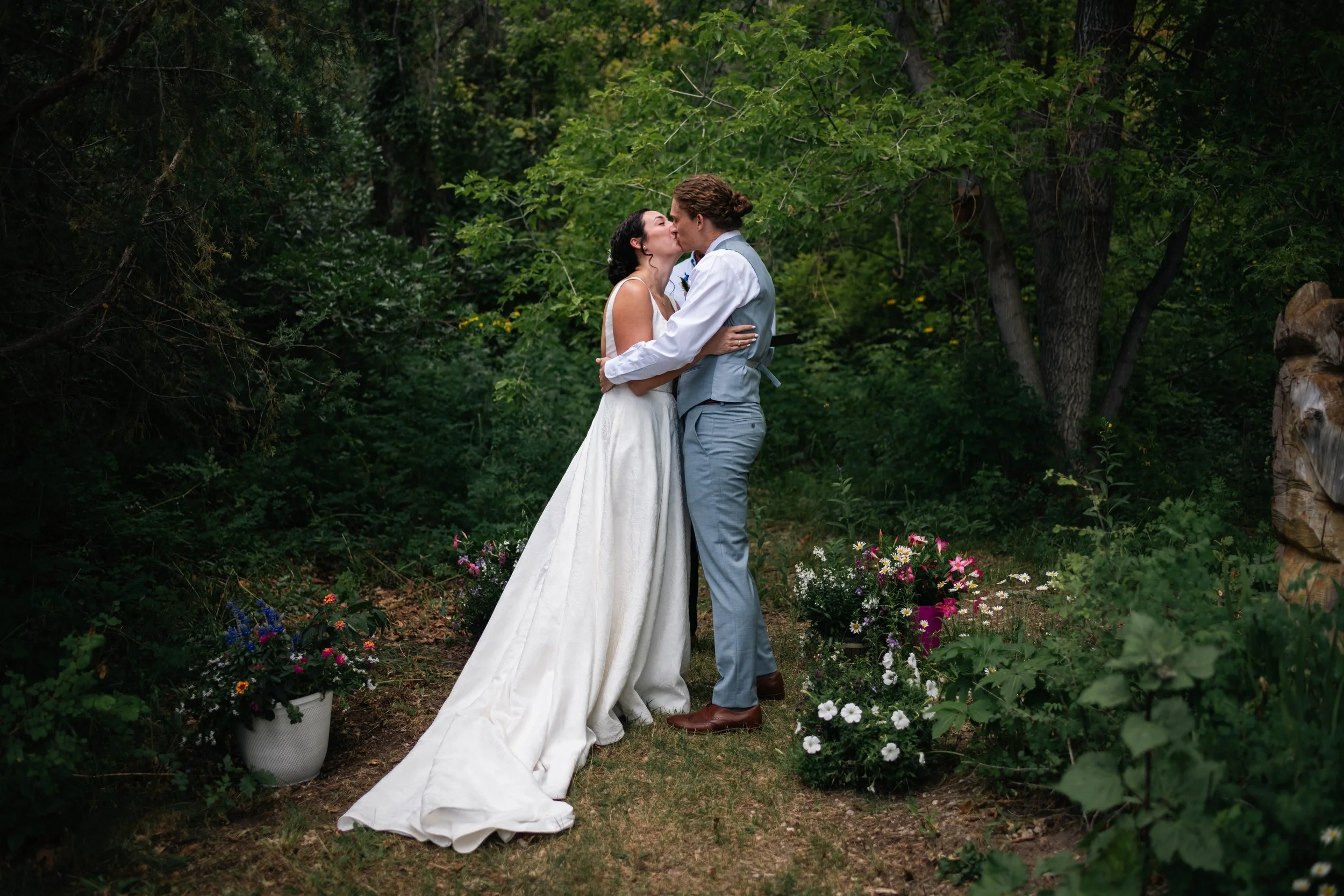 Couple sharing a kiss during their outdoor wedding ceremony in Albuquerque New Mexico
