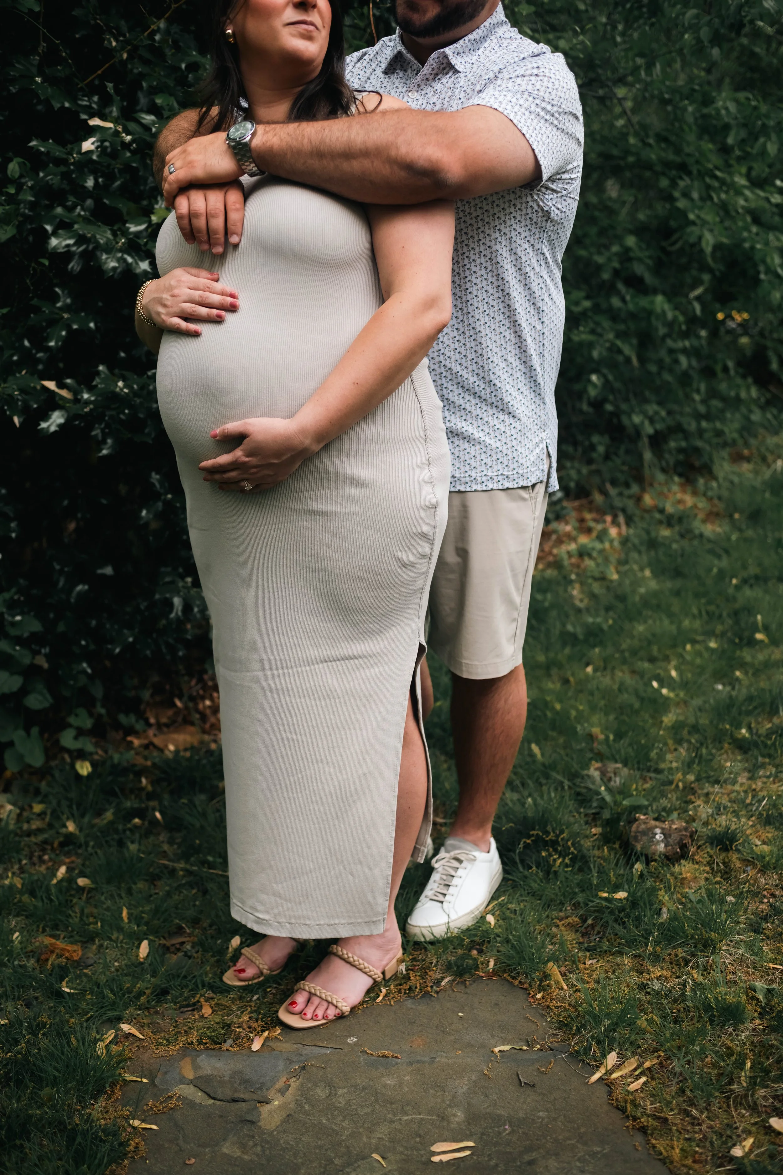 Couple embracing a baby bump during a maternity photo session in New Jersey