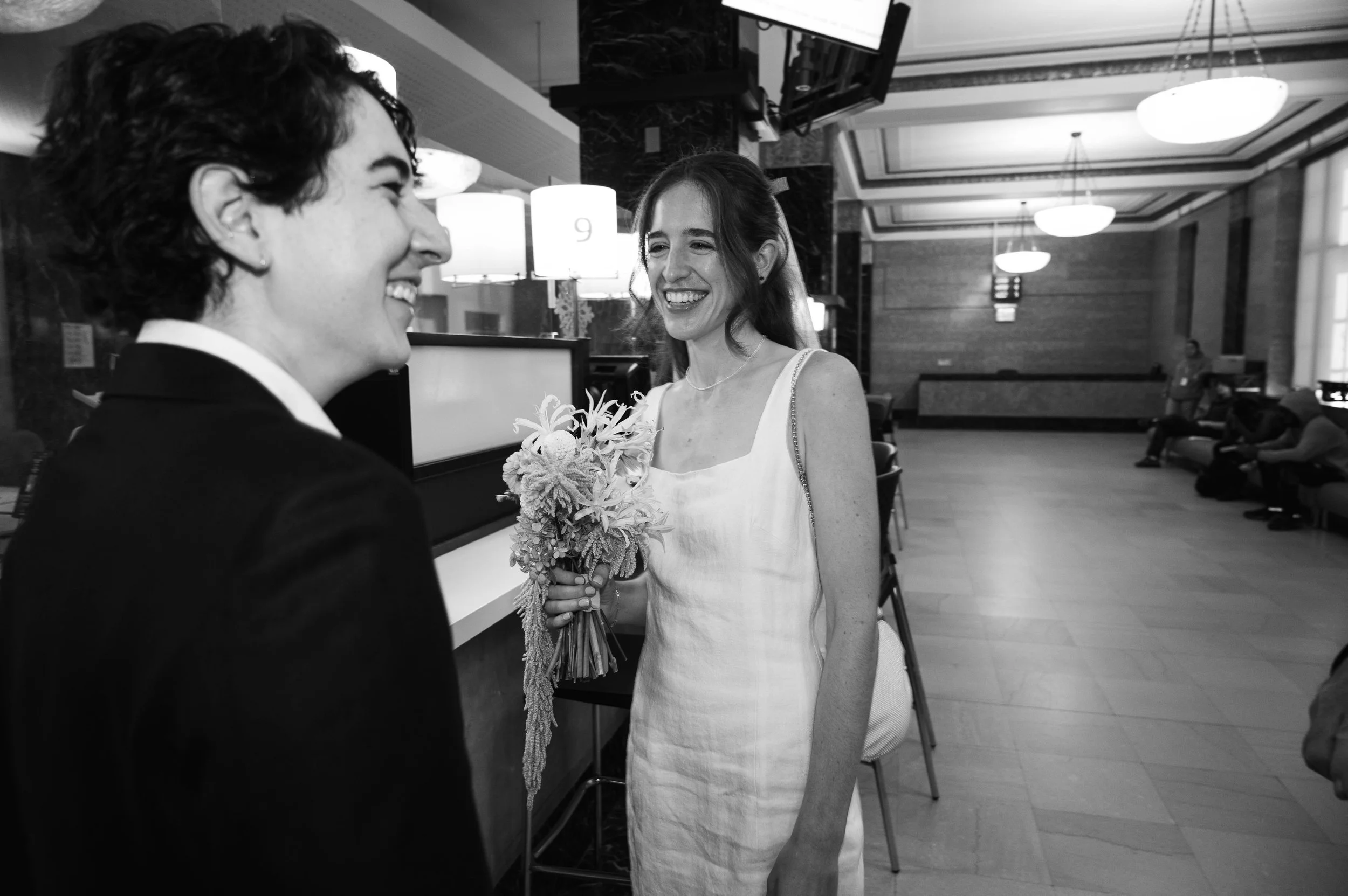 Couple laughing together after signing their marriage papers at the Manhattan courthouse
