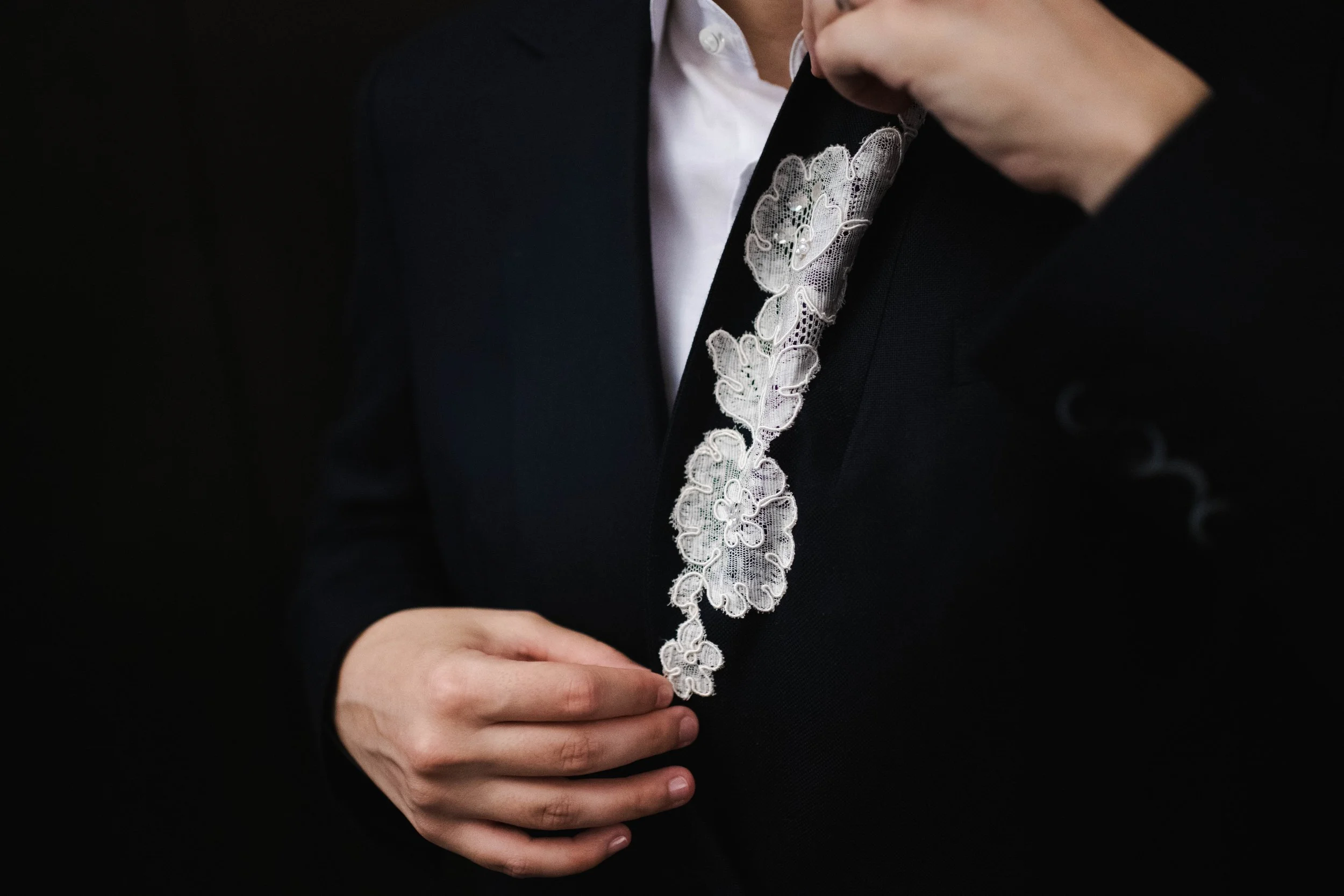 Detail shot of a bride's wedding suit before her NYC courthouse ceremony