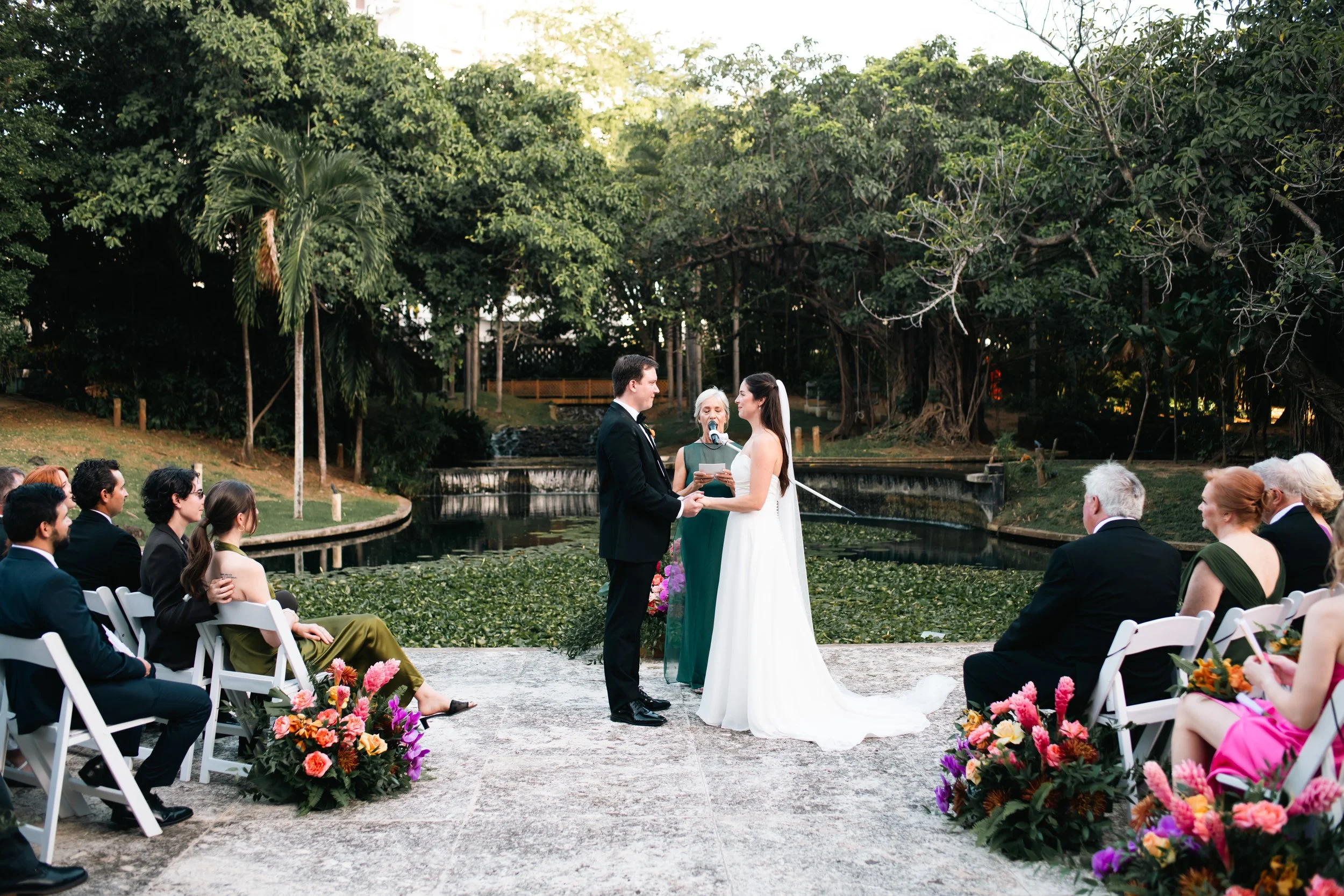 bride-groom-exchanging-vows-lily-pond-ceremony-mapr-san-juan-puerto-rico-wedding.jpg