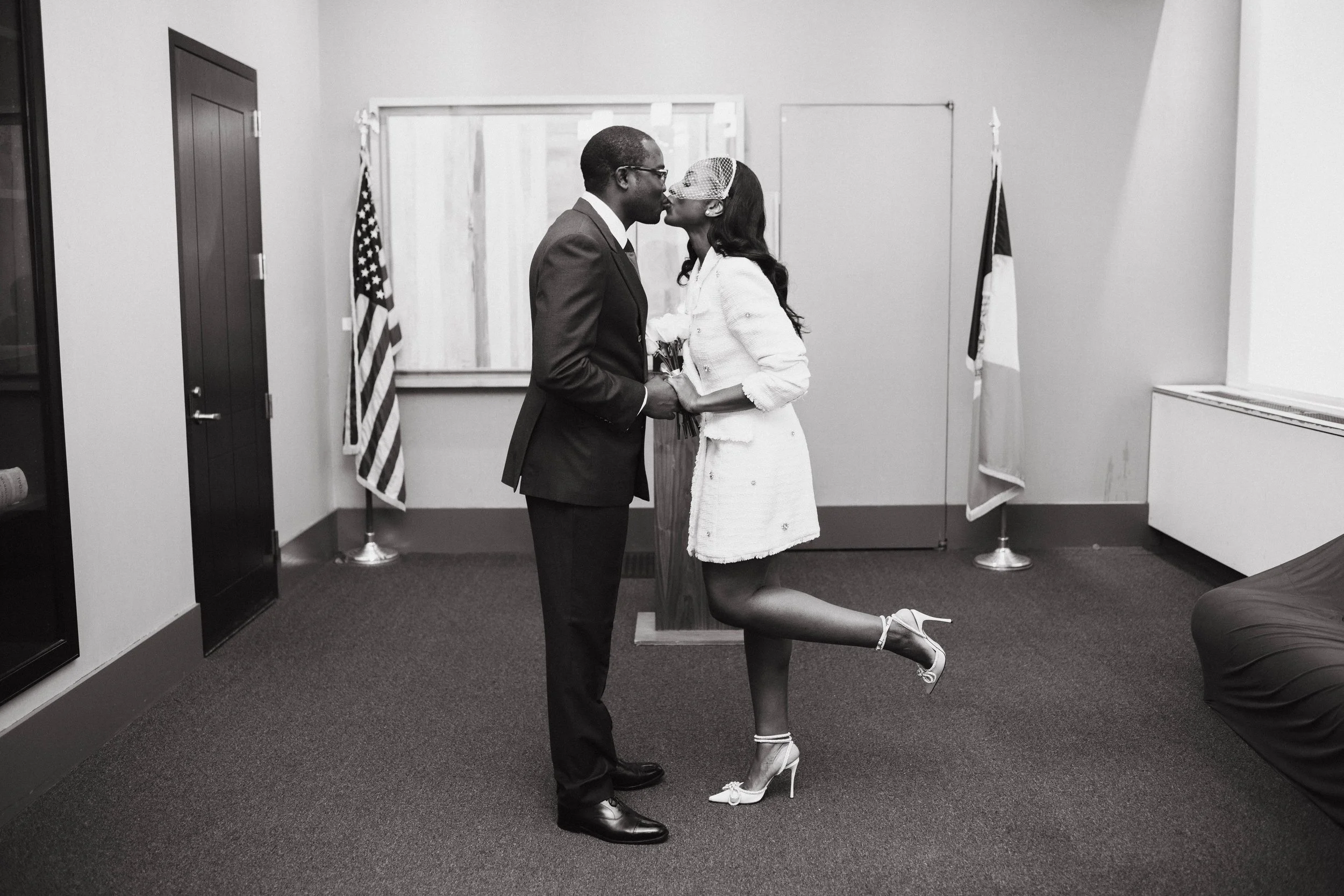 Couple sharing a kiss during their civil ceremony inside the Manhattan courthouse