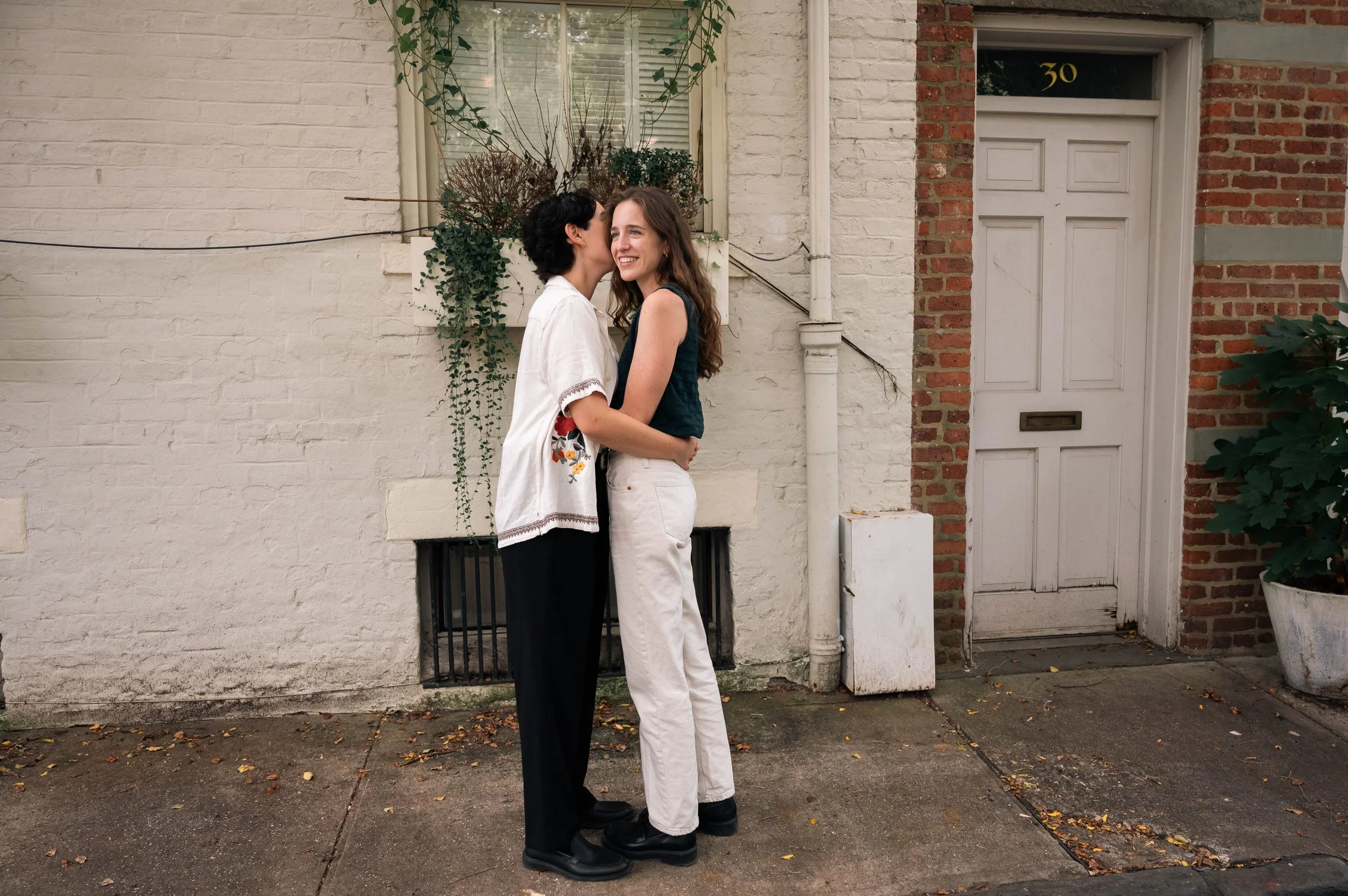 Queer couple sharing an intimate moment during a documentary engagement session in Brooklyn