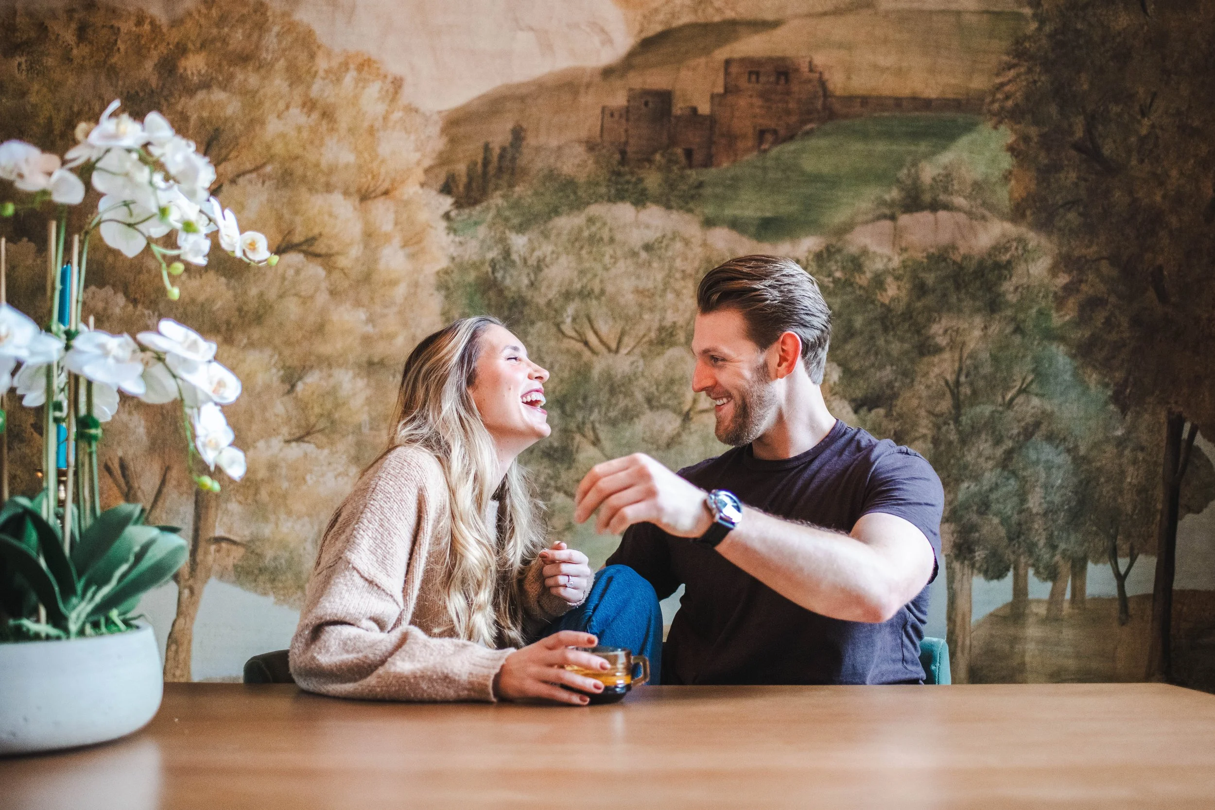 Couple laughing during an at-home engagement photoshoot in Tribeca NYC