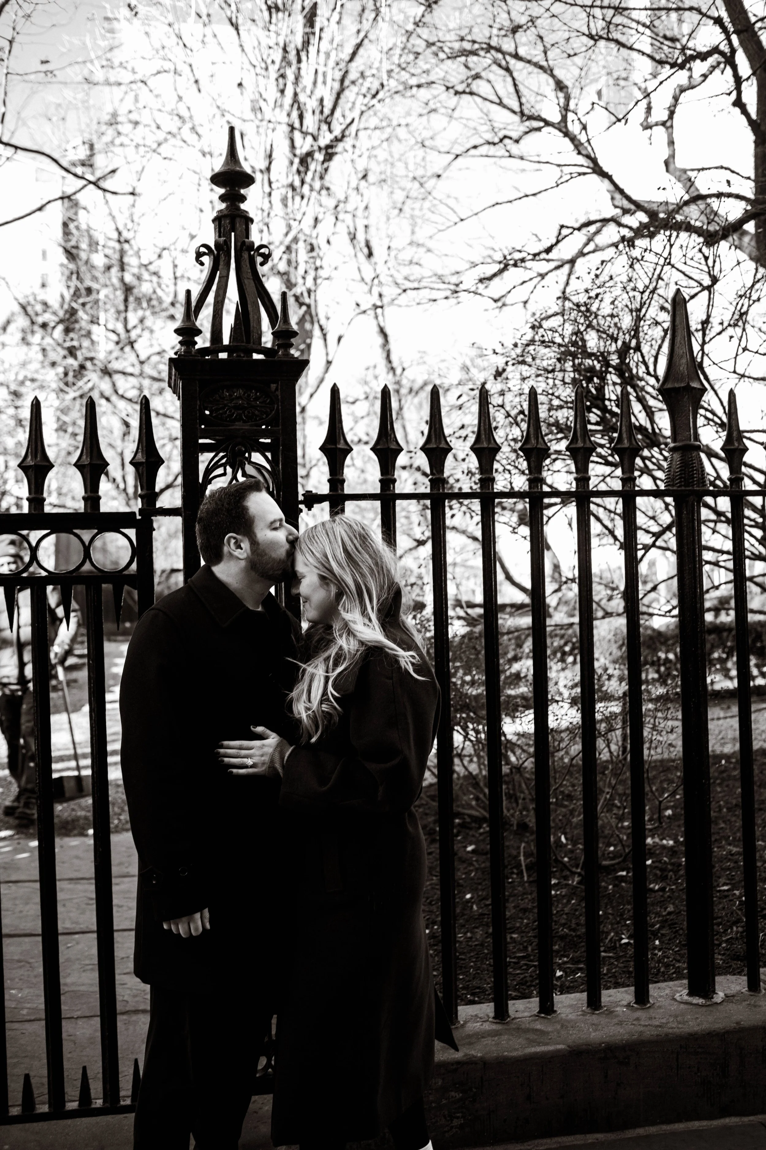 Couple embracing in Gramercy Park after a marriage proposal in New York City