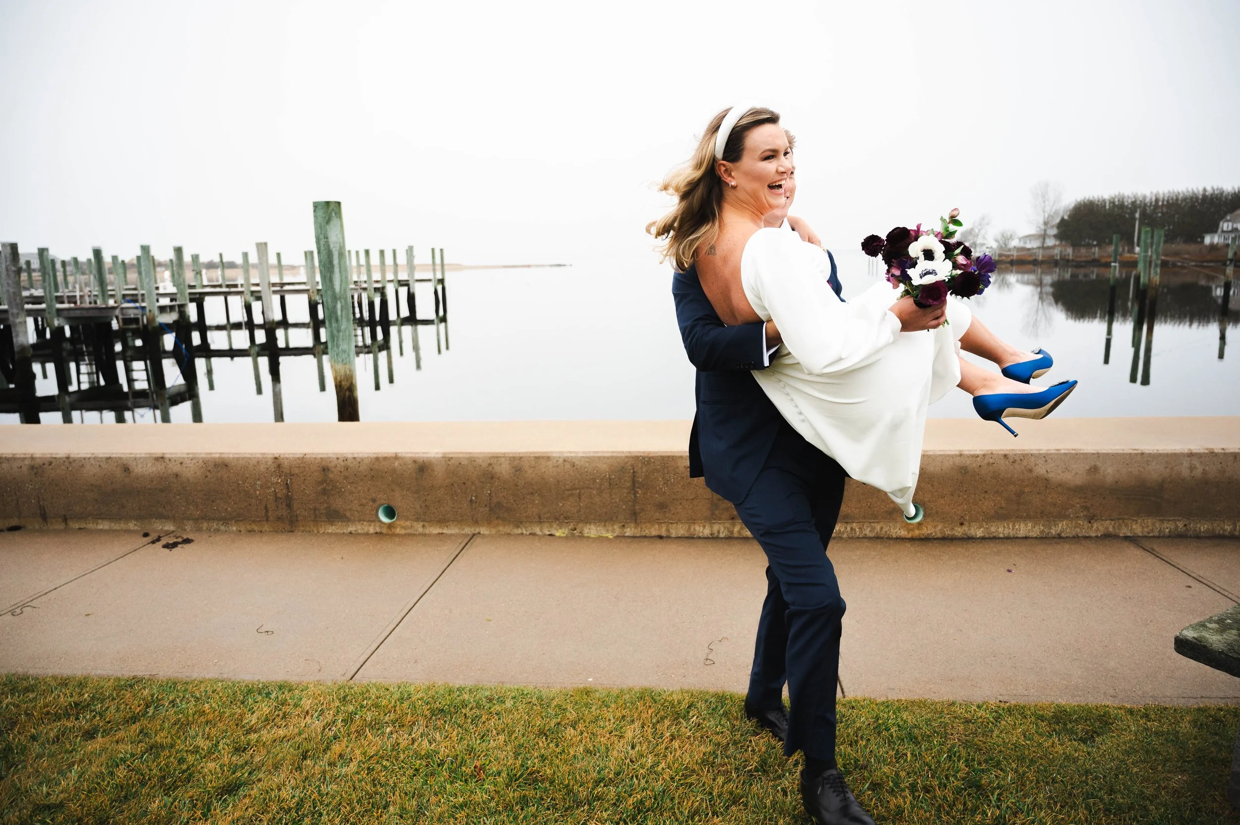 Groom lifting his bride during their wedding celebration in Watch Hill Rhode Island