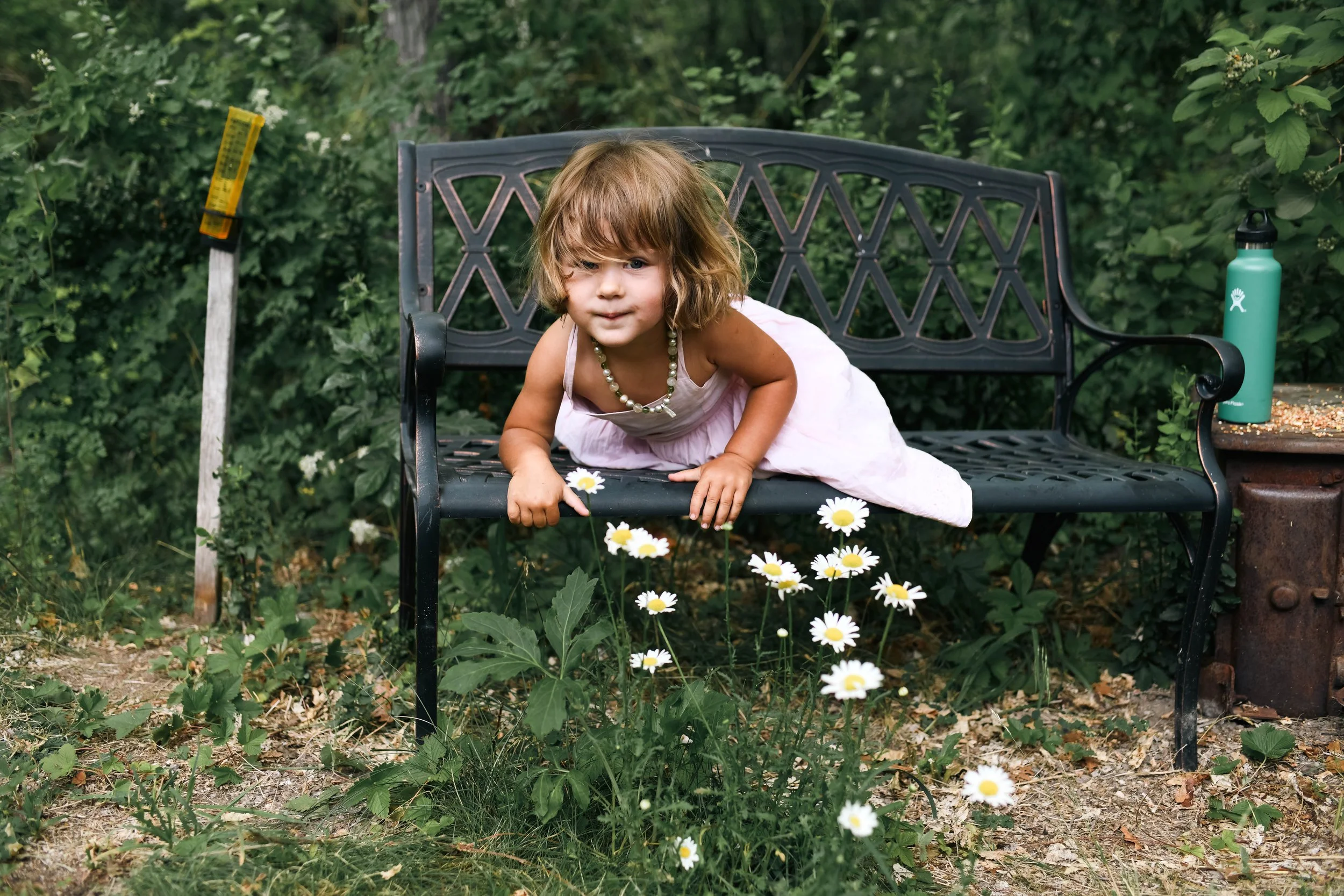Flower girl sitting on a bench watching the wedding ceremony in Albuquerque New Mexico