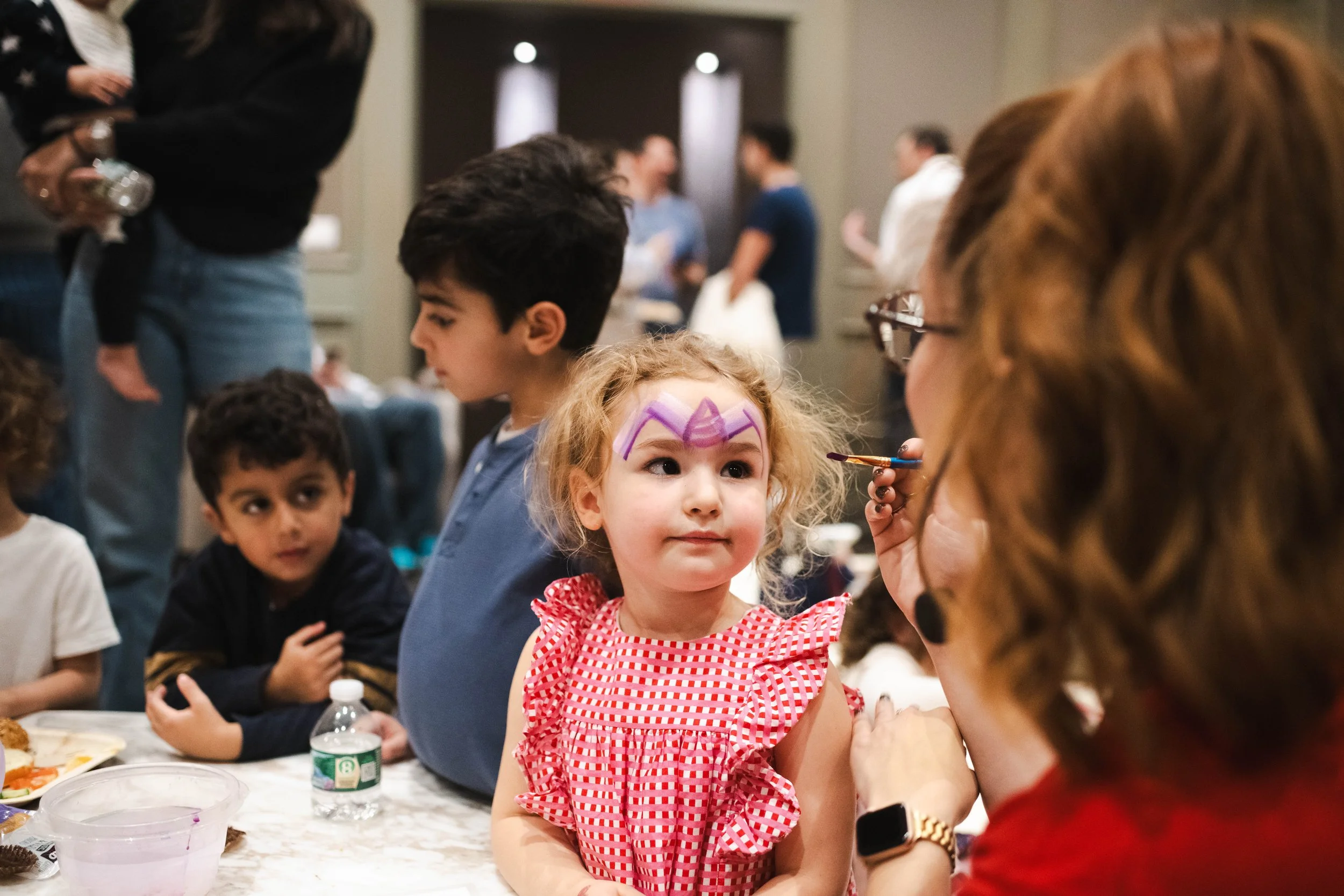 Girl getting her face painted at a birthday party in New York City