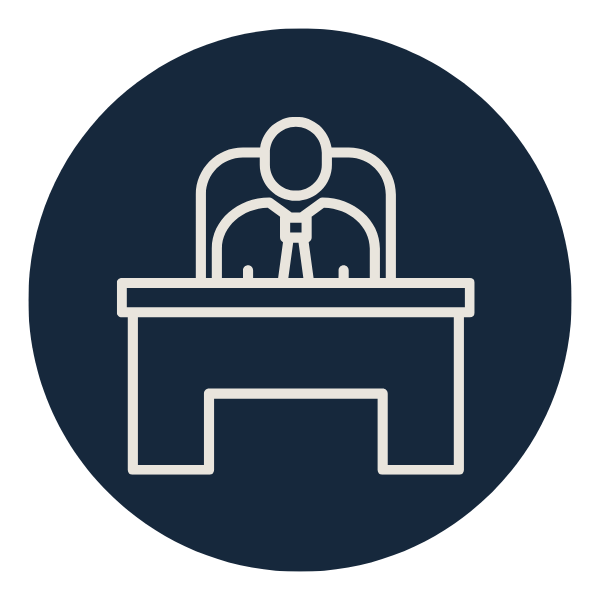 An outline of a person sitting at a desk, possibly a judge or official, wearing a tie, in a circular icon with a dark background.