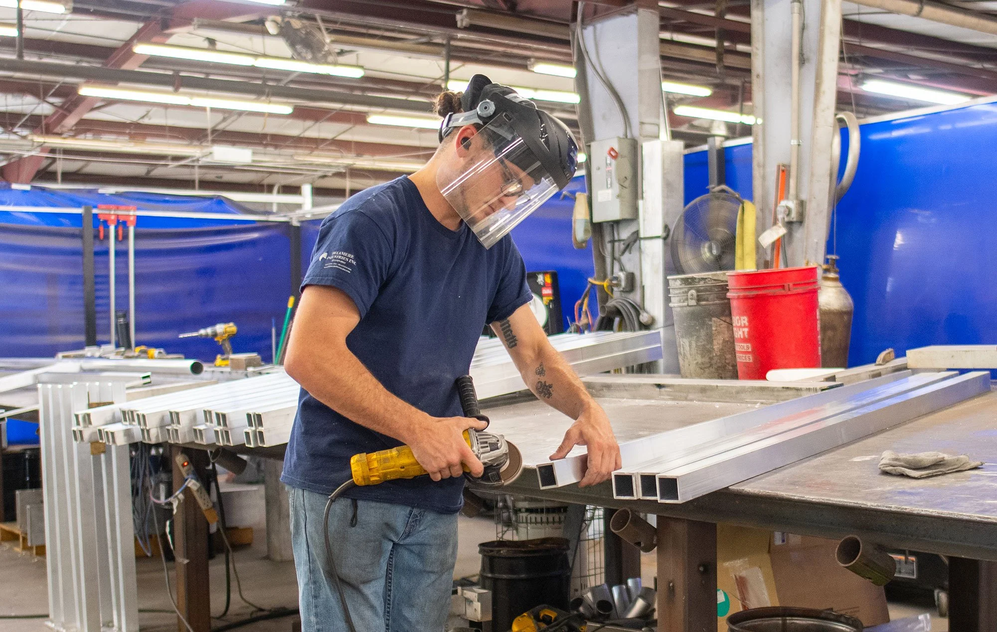 Delamere worker grinding metal struts