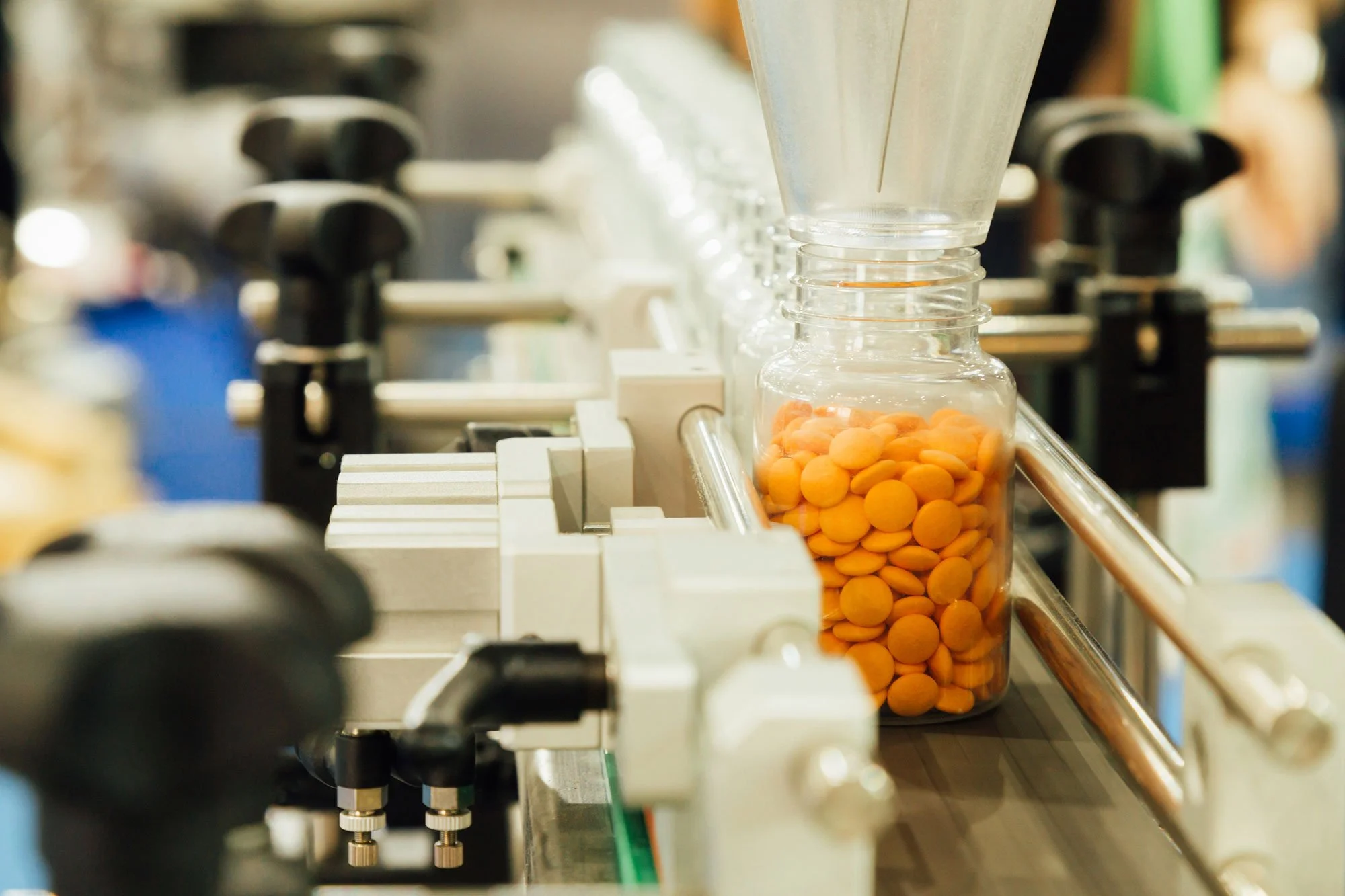 bottles being filled with pills on production line