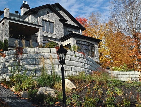 Completed Redi-Rock retaining wall project providing structural support and landscape improvement.