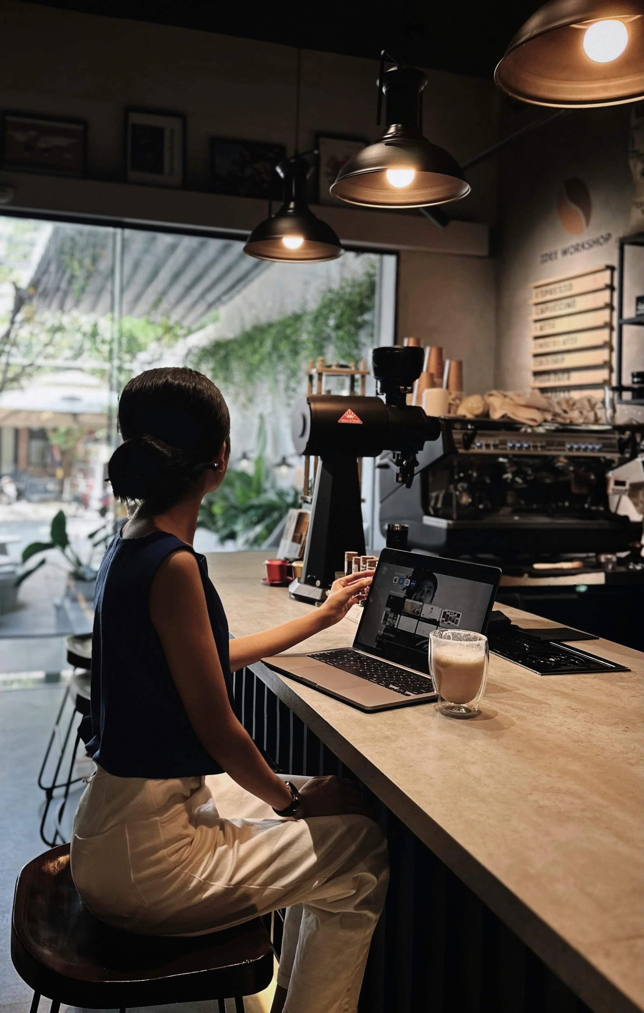 Young woman on a cafe working on her laptop