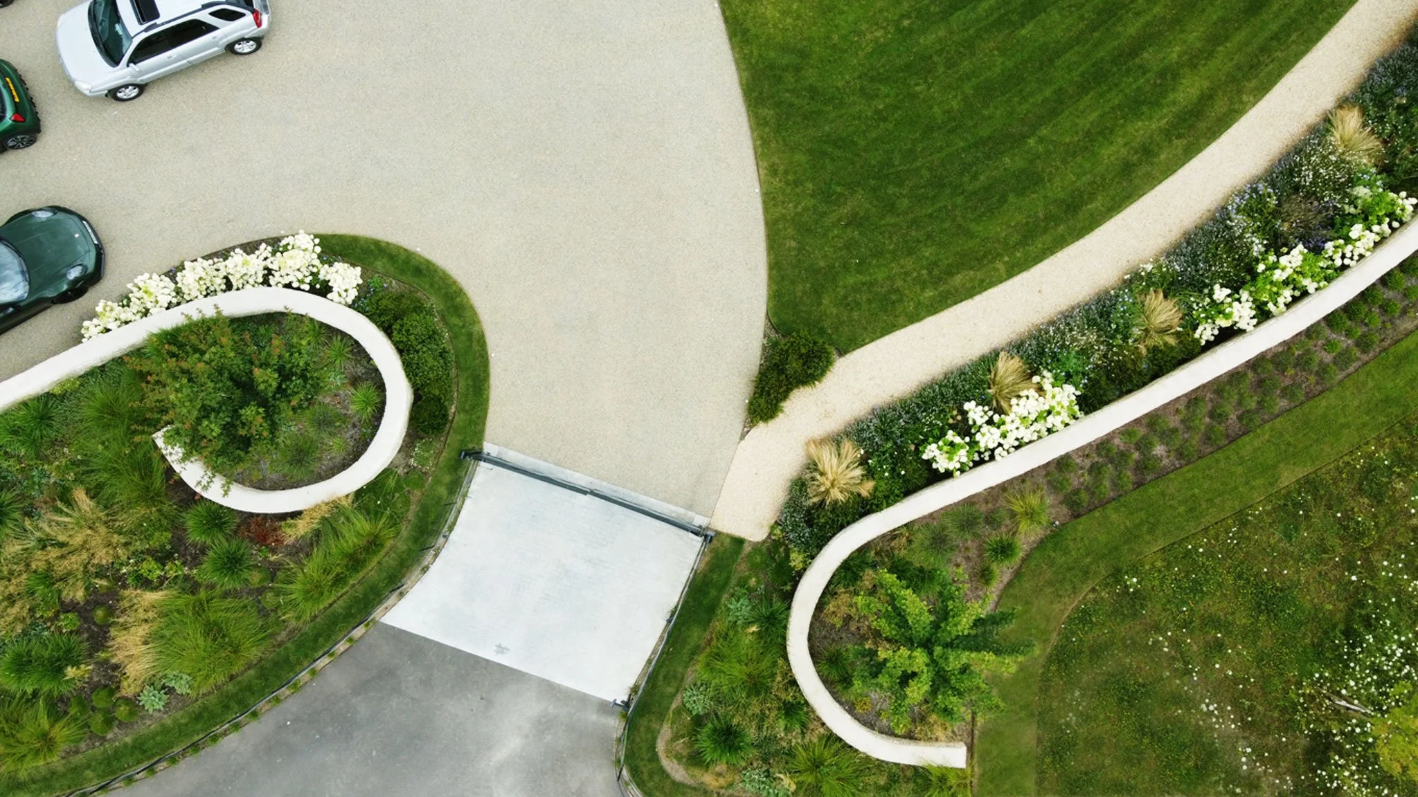 Spiralling walls wrap around field maples and create informal entrance.