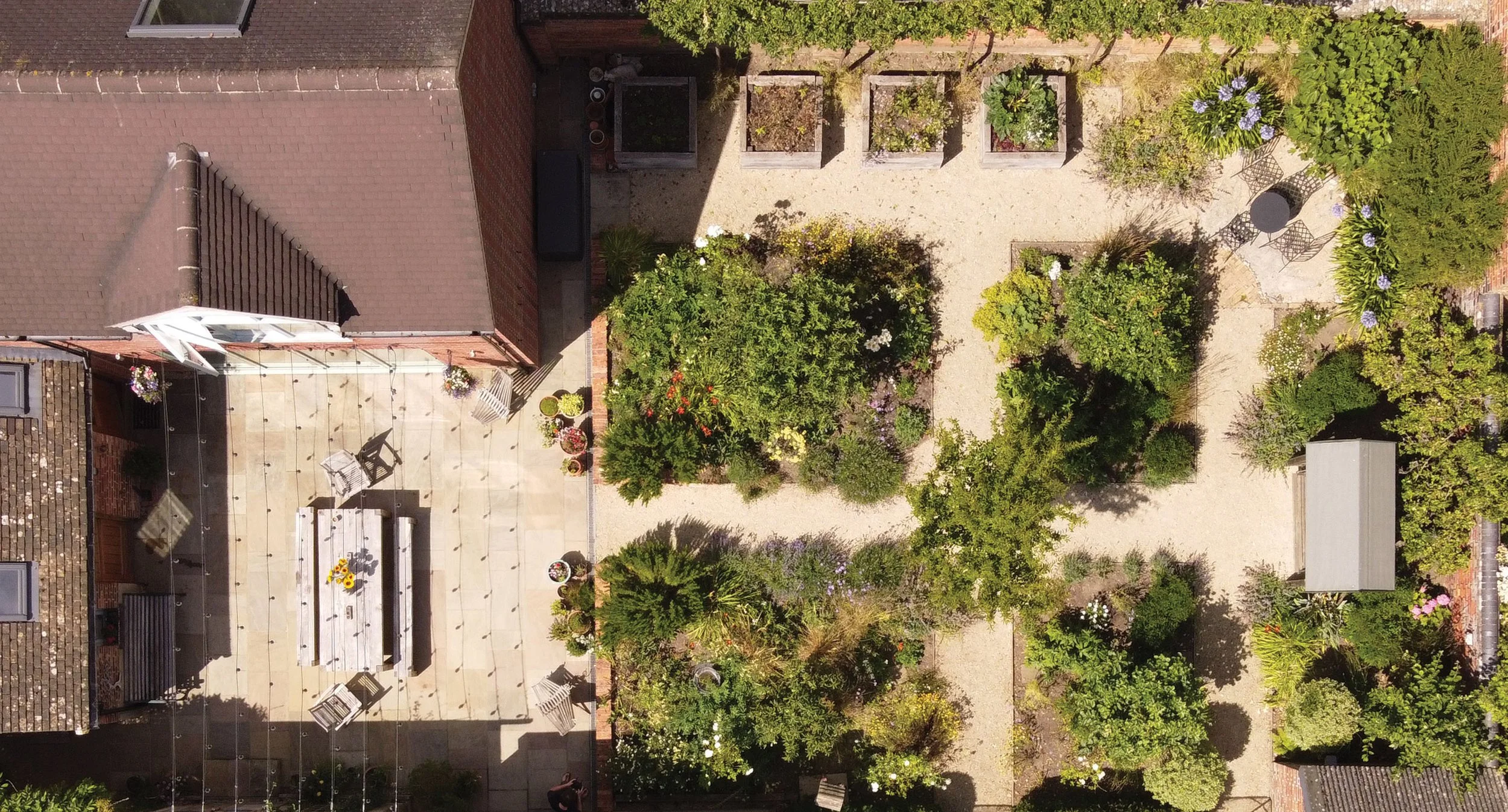 Aerial view of The Quad Garden in Yarnton, Oxfordshire, showing the formal courtyard layout, planted quadrants and productive garden.