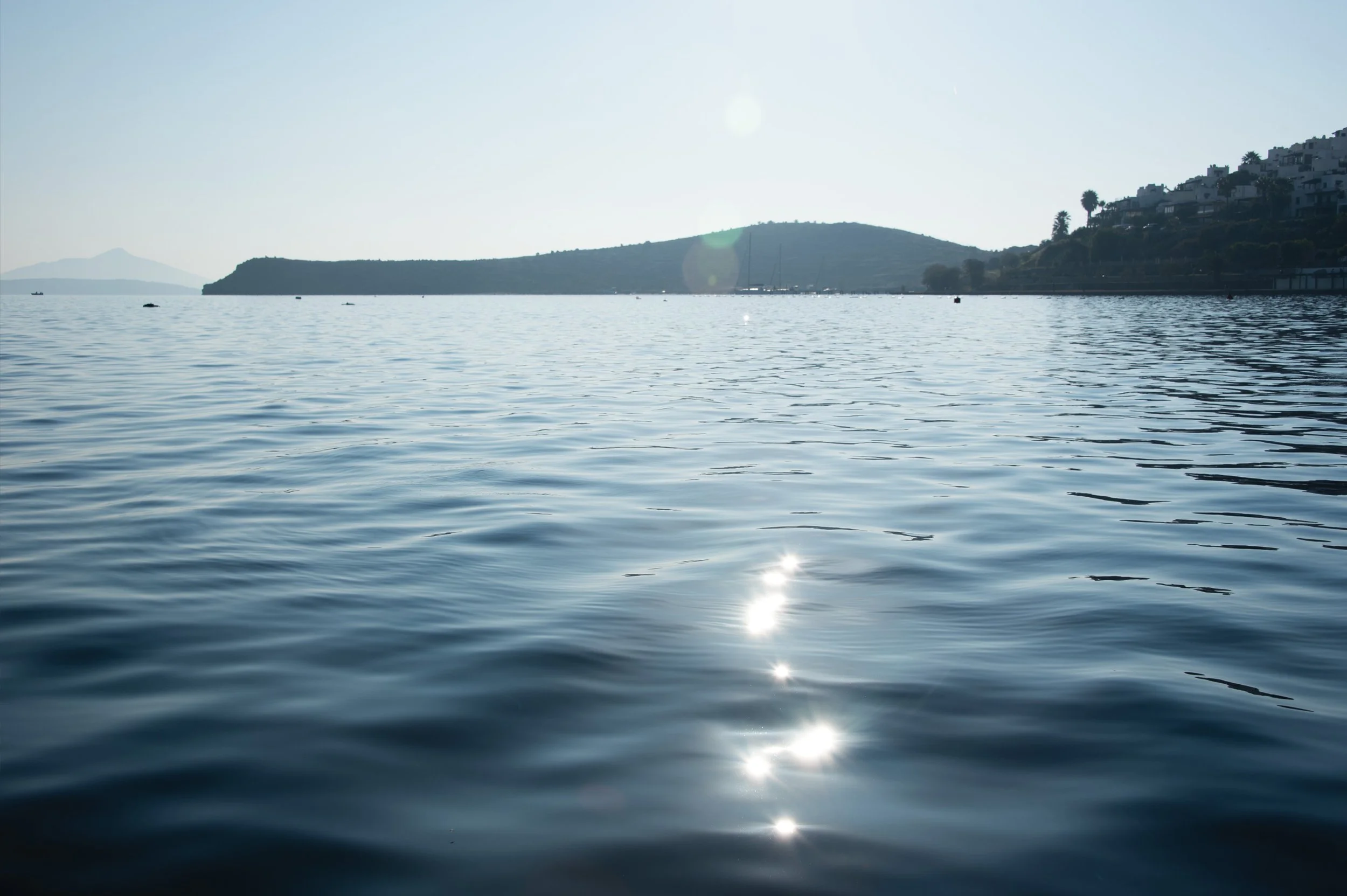 Sunlight reflecting across rippling seawater off the coast of Bodrum, Turkey.