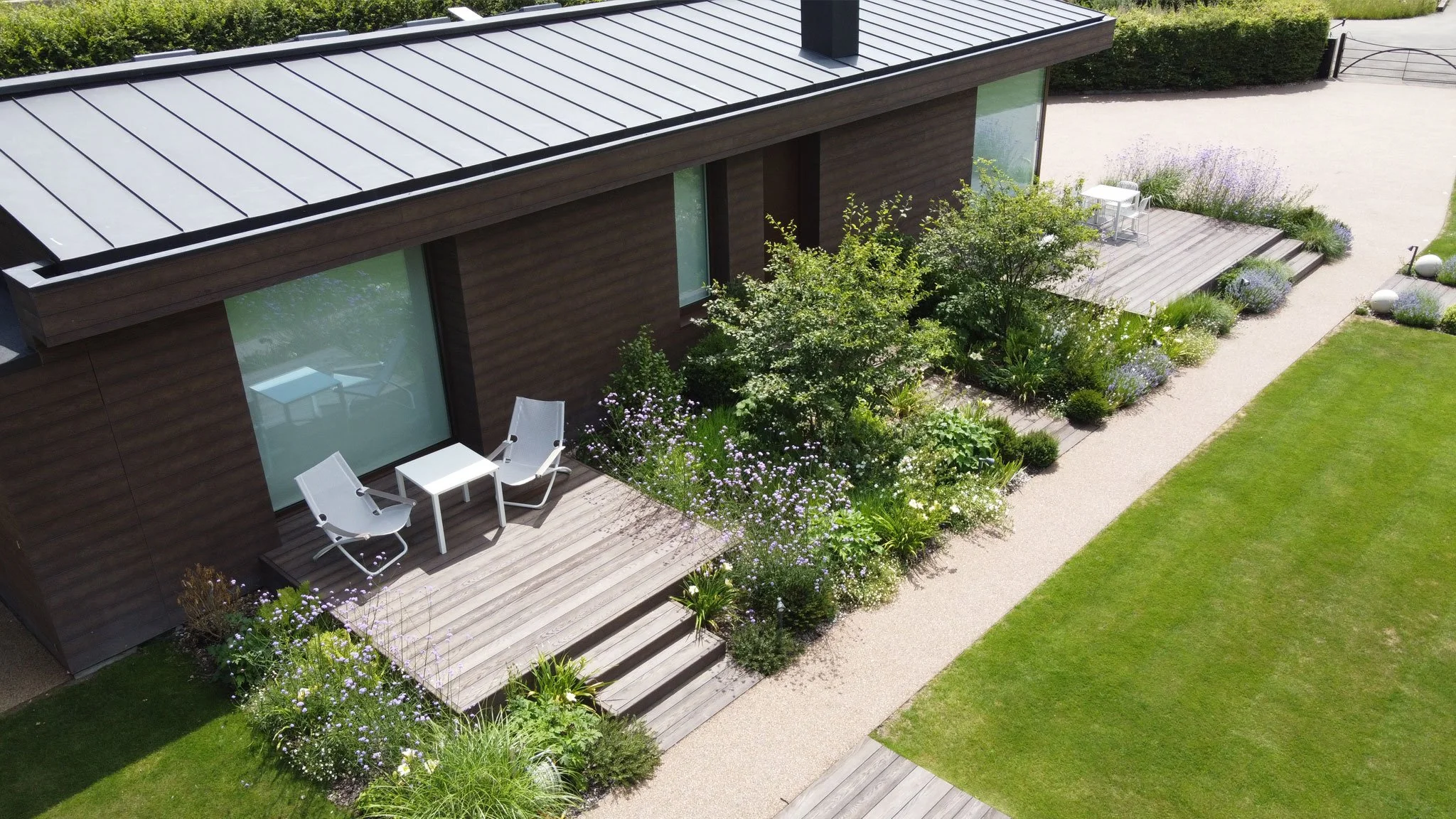 Aerial view of the contemporary barn conversion with Millboard decking and naturalistic planting surrounding the terrace.