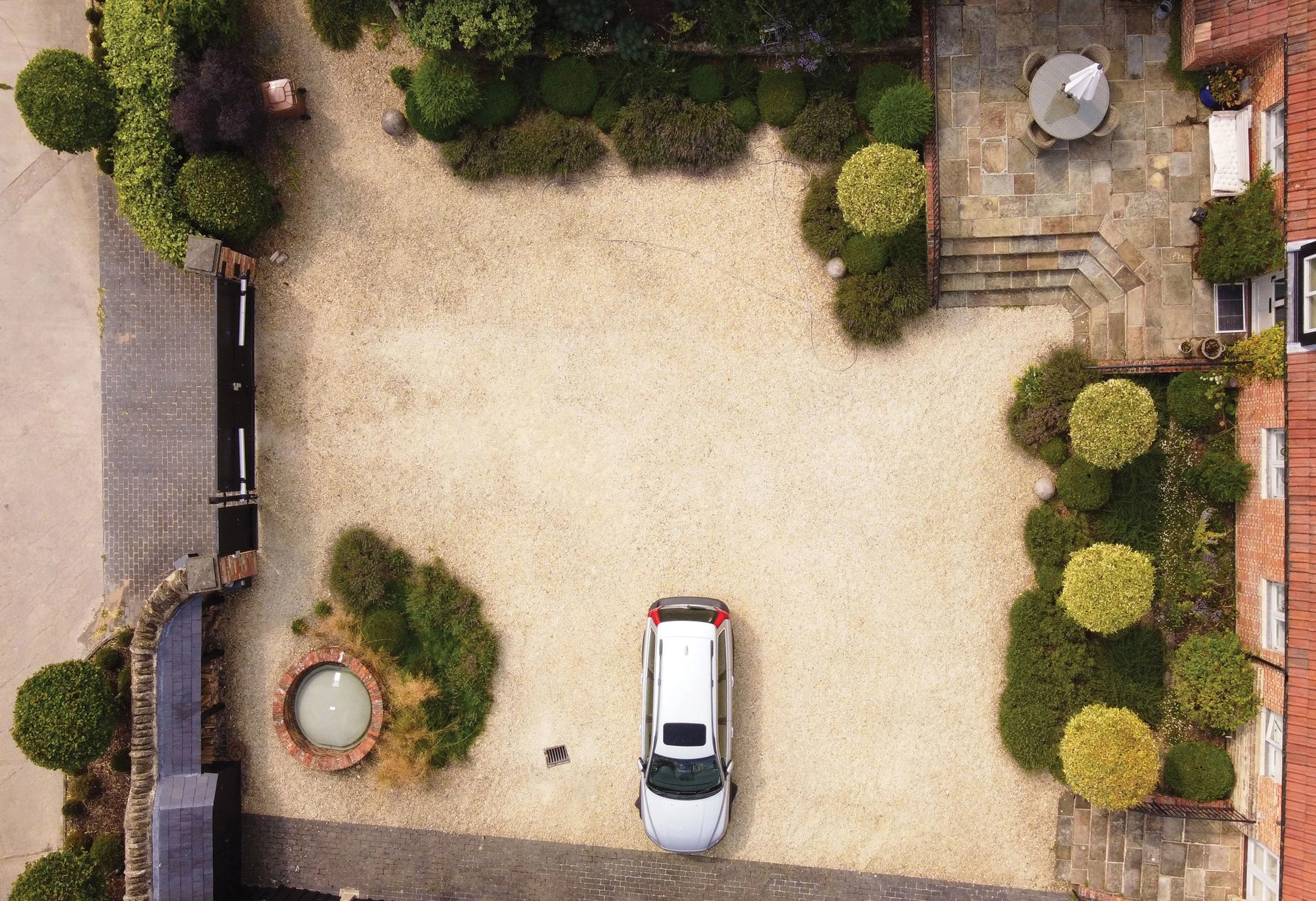 Overhead view of loose gravel planting contrasted with the formal repetition of small trees in the courtyard garden.