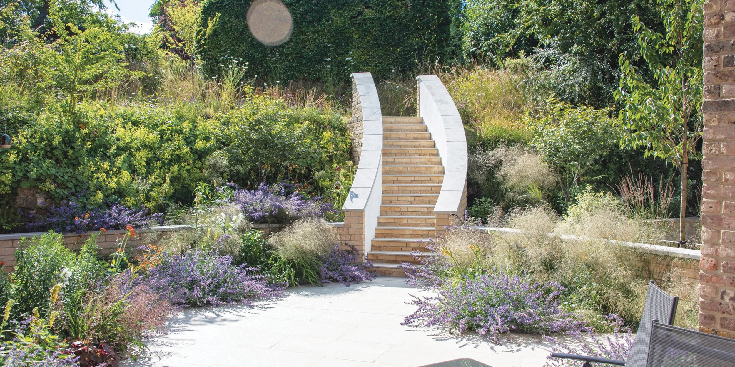 Curved garden staircase with naturalistic planting in a contemporary Oxfordshire garden designed by Doug Holloway Landscape Design.”