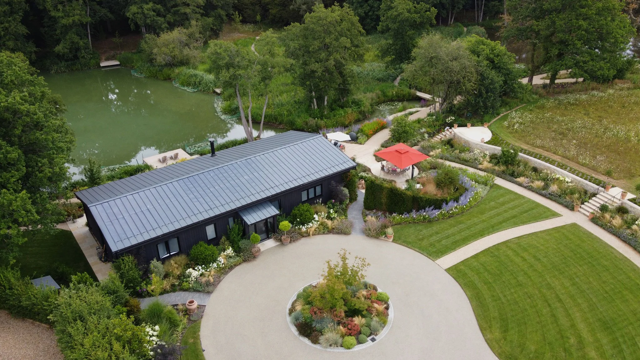 Circular entrance drive and curved hedge from front garden at The Lake House