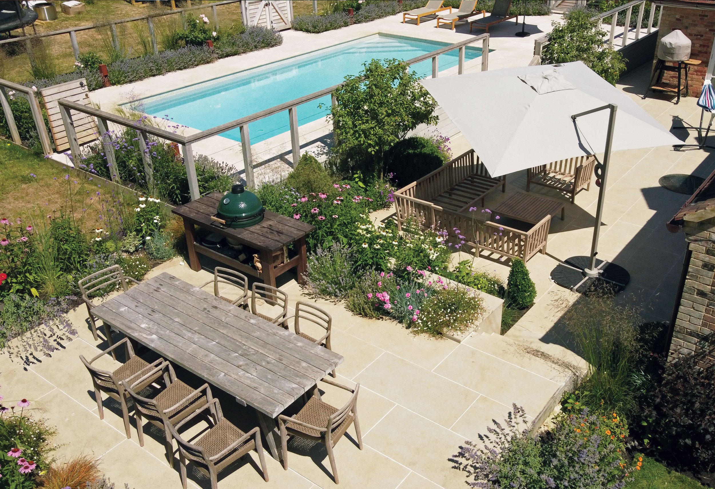 Aerial view of the family dining terrace, pool garden and planting connecting the different outdoor spaces.