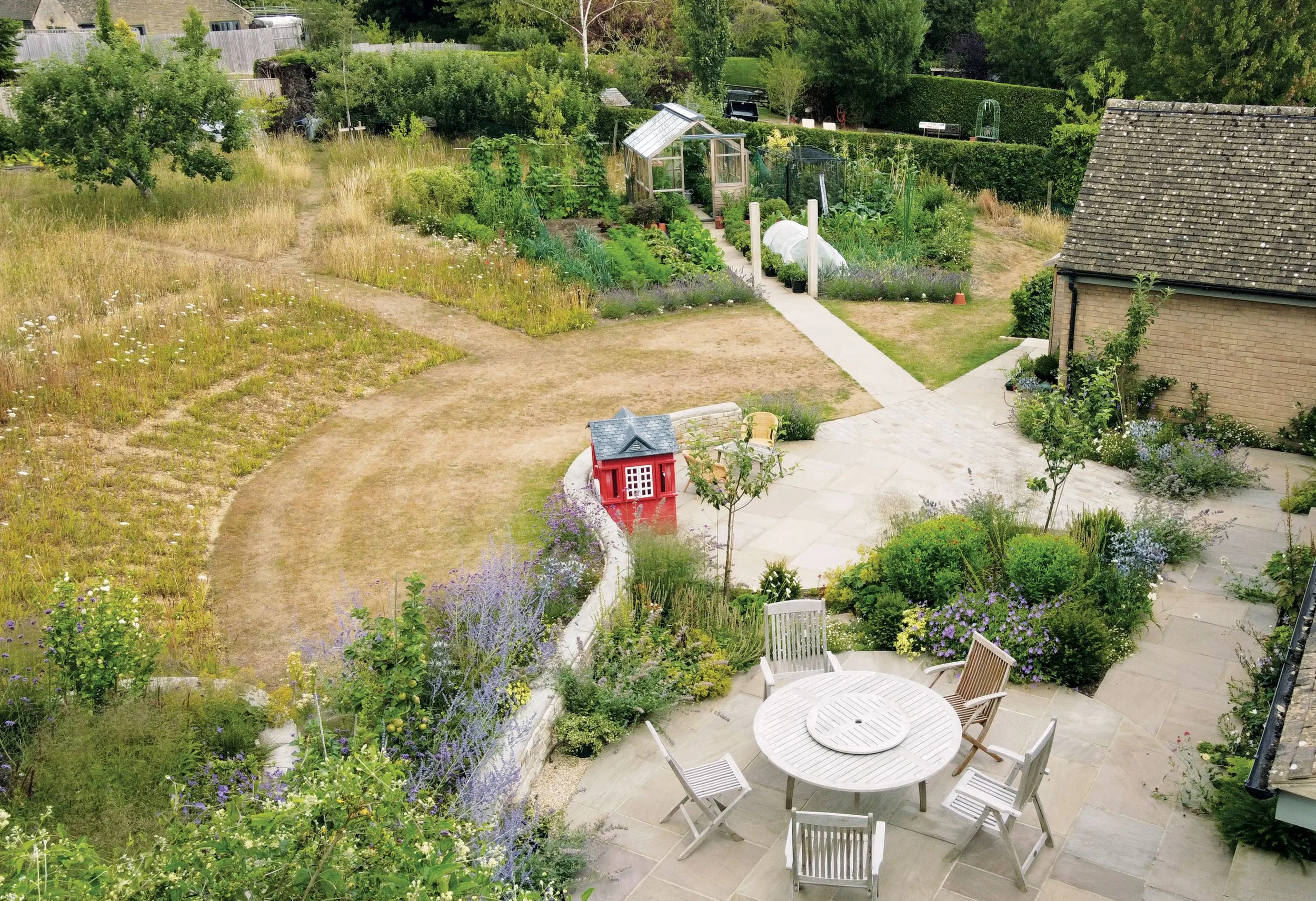 View from the family terrace towards the productive kitchen garden and Gabriel Ash greenhouse beyond.