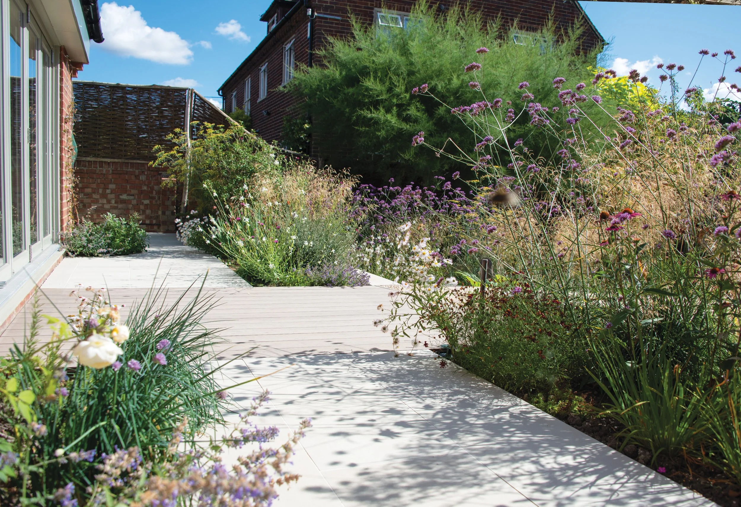 Decking and Paving meet seamlessly and perennials cast shadows in this playful contemporary space