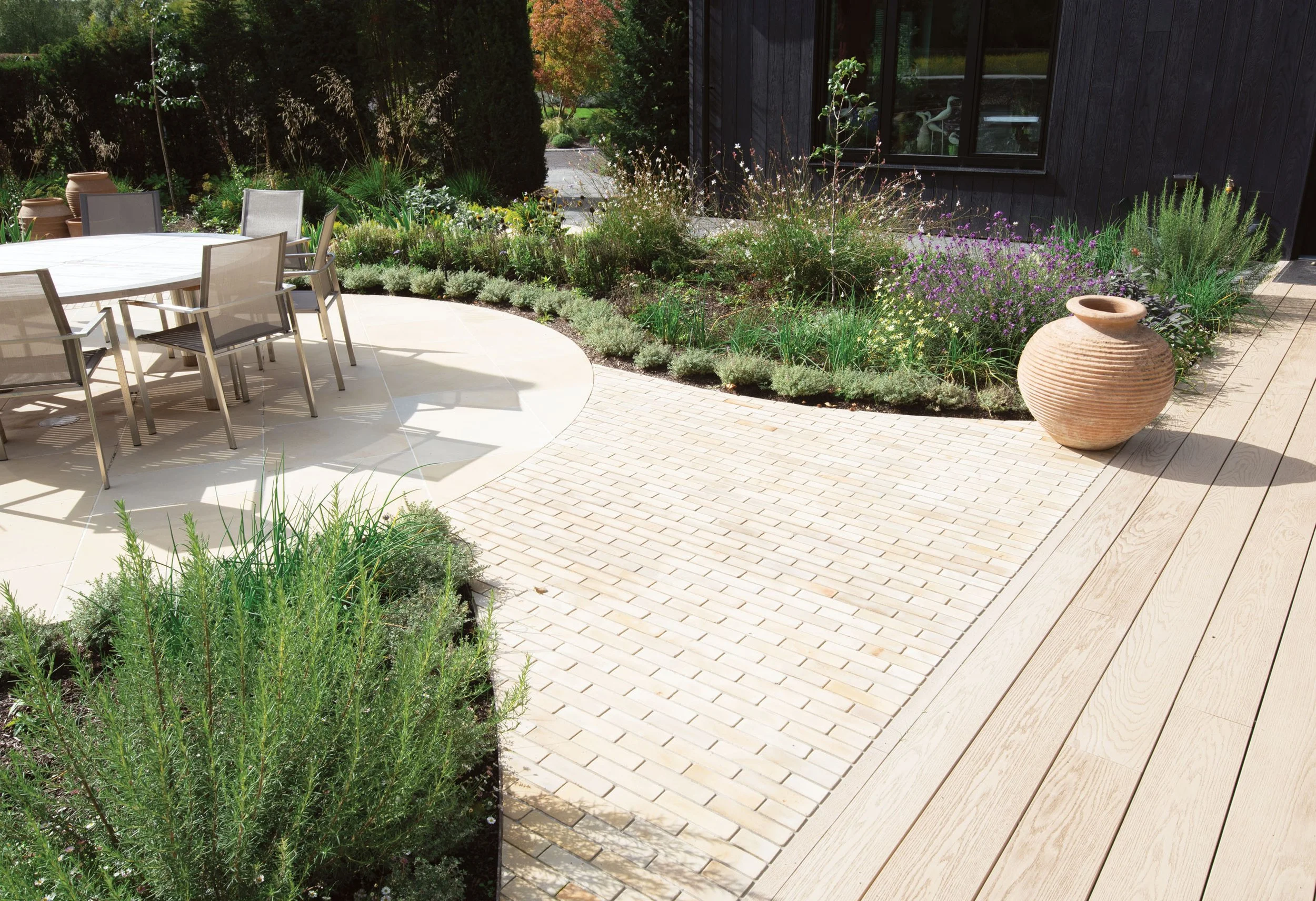 Flowing landscape design, material detailing, stone bricks -Harvest from London Stone) Harvest Paving and Millboard Decking