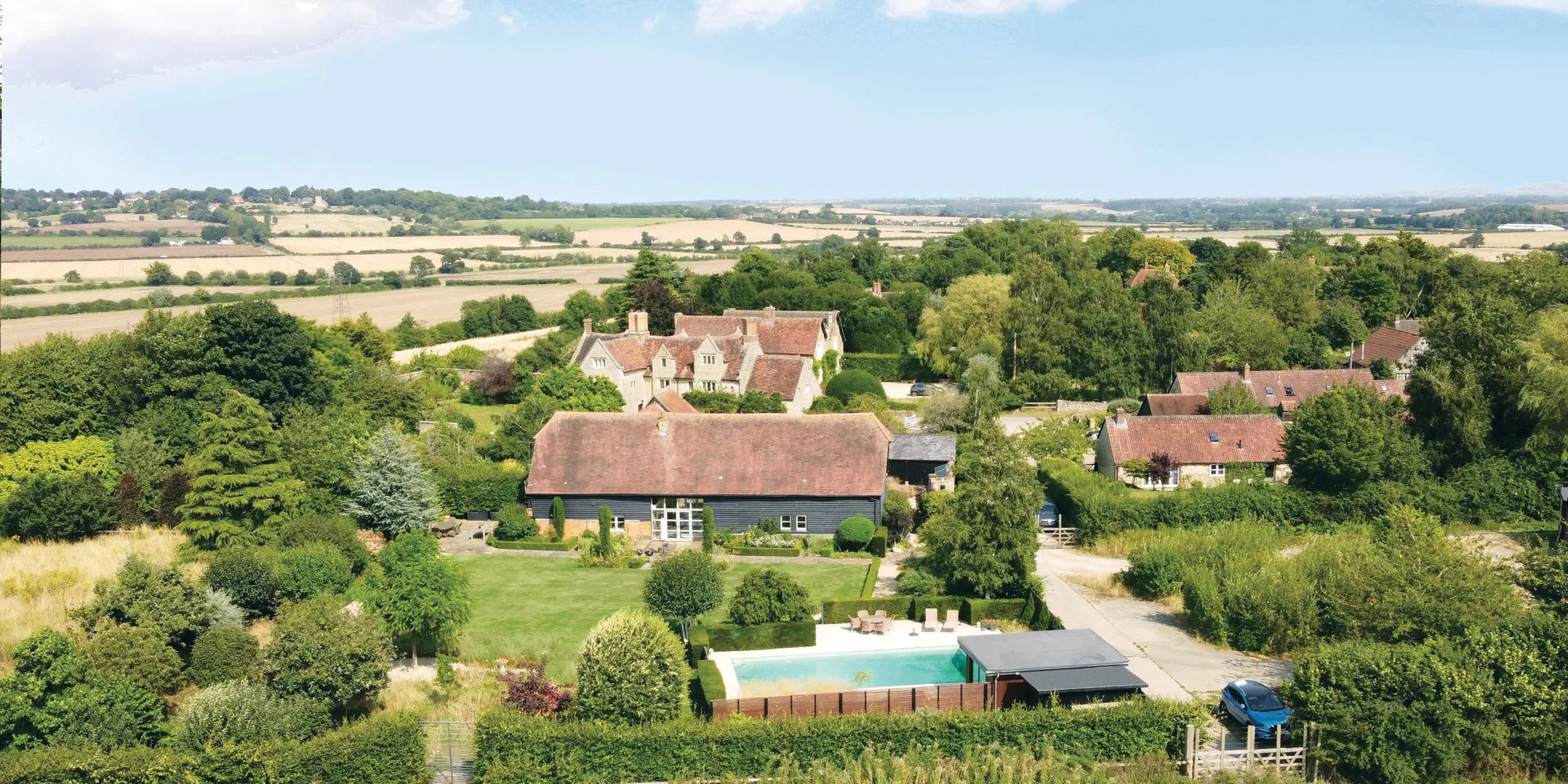 Formal garden design in Oxfordshire with structured layout and surrounding landscape