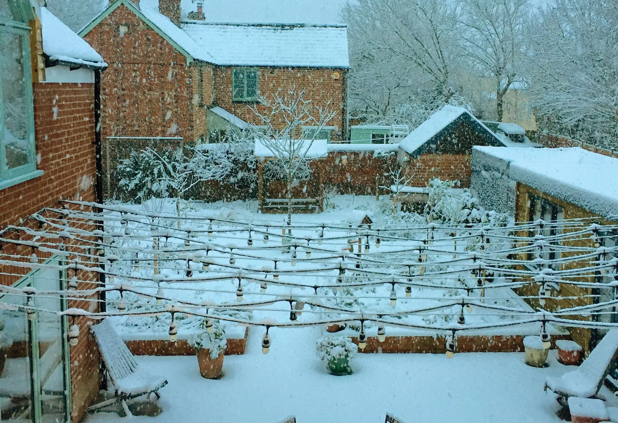 The courtyard garden in winter, showing the structure of the garden and its relationship with the surrounding buildings.