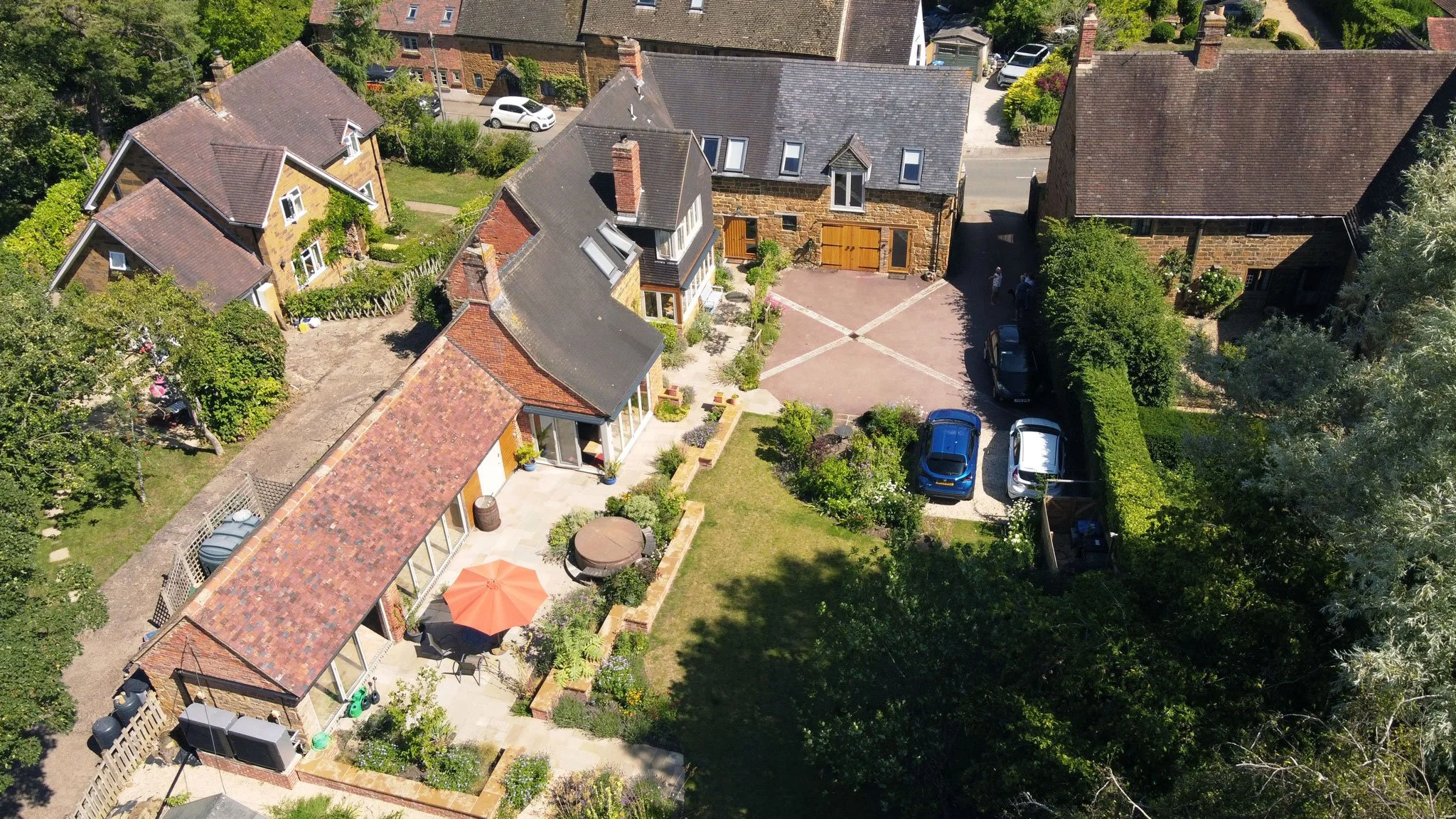 Aerial view of the courtyard garden showing how planting, parking, entertaining spaces and the historic buildings are brought together.