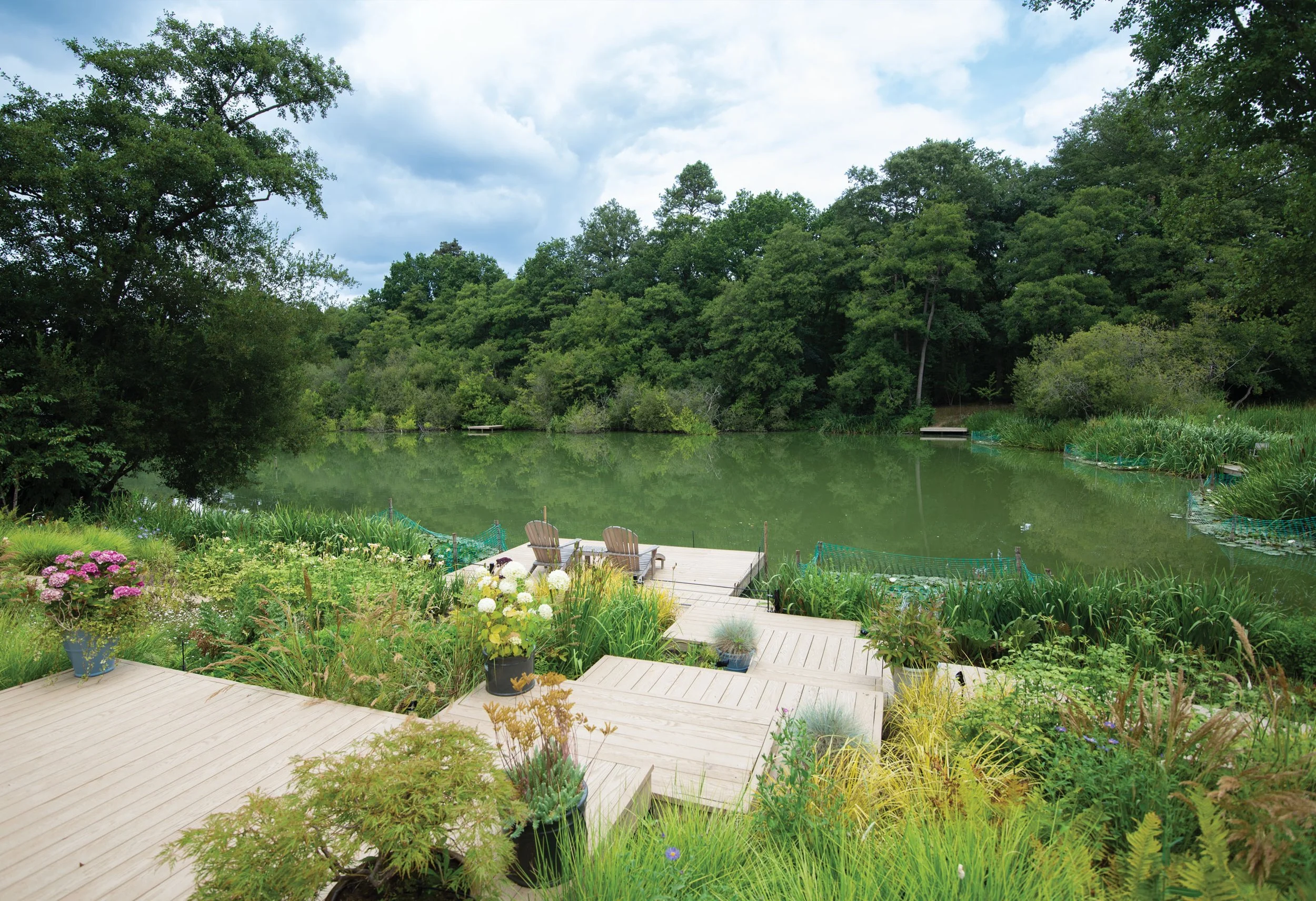 Floating Lilly Pad decking leads down to lake, the Lake House Surrey
