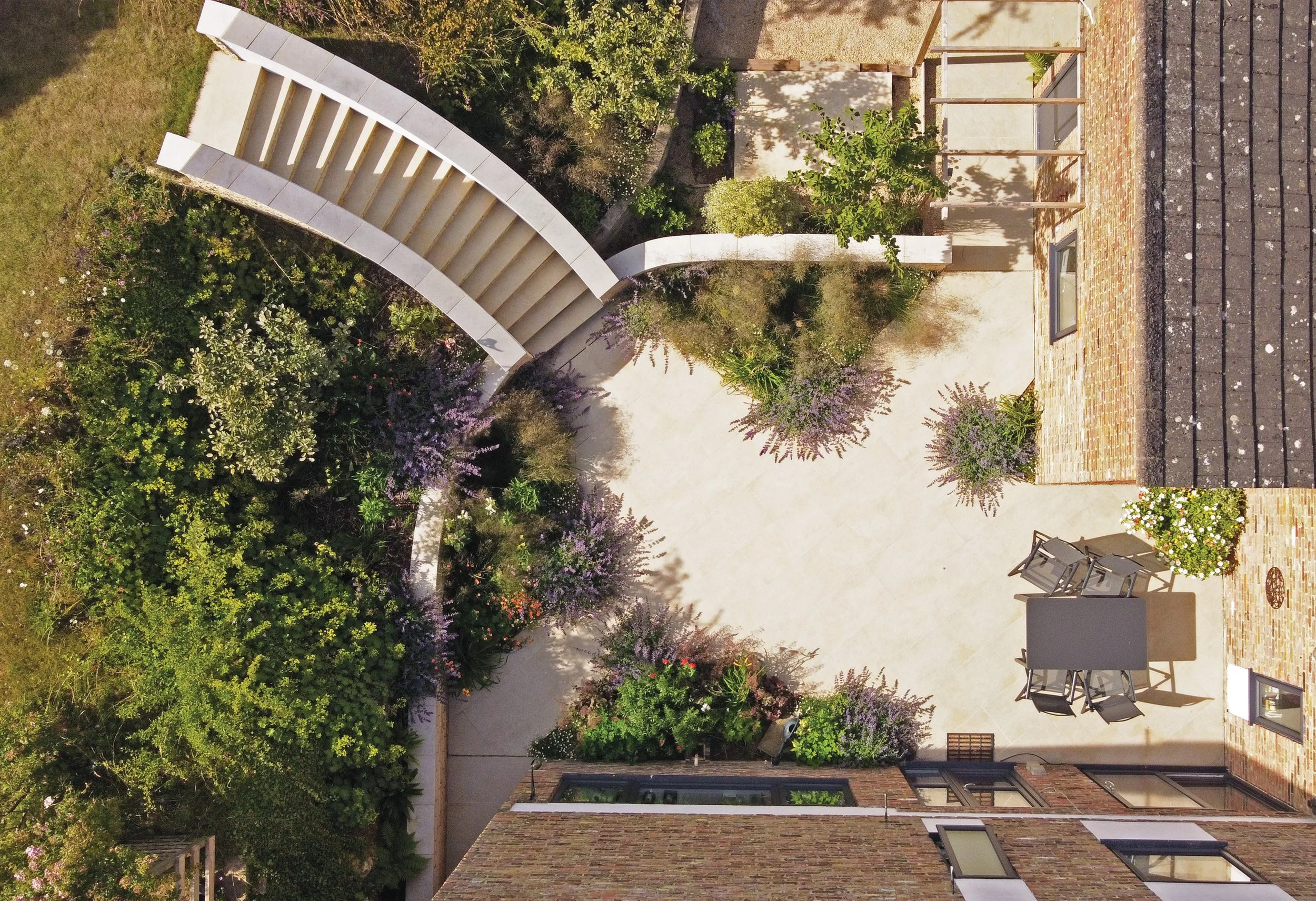 Overhead view shows formal geometry juxtaposed with wild naturalistic planting in the lower seating terrace at The Sunken Garden, designed by Doug Holloway.