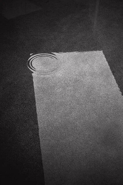 Ripples on the surface of water with a geometric object beneath it.