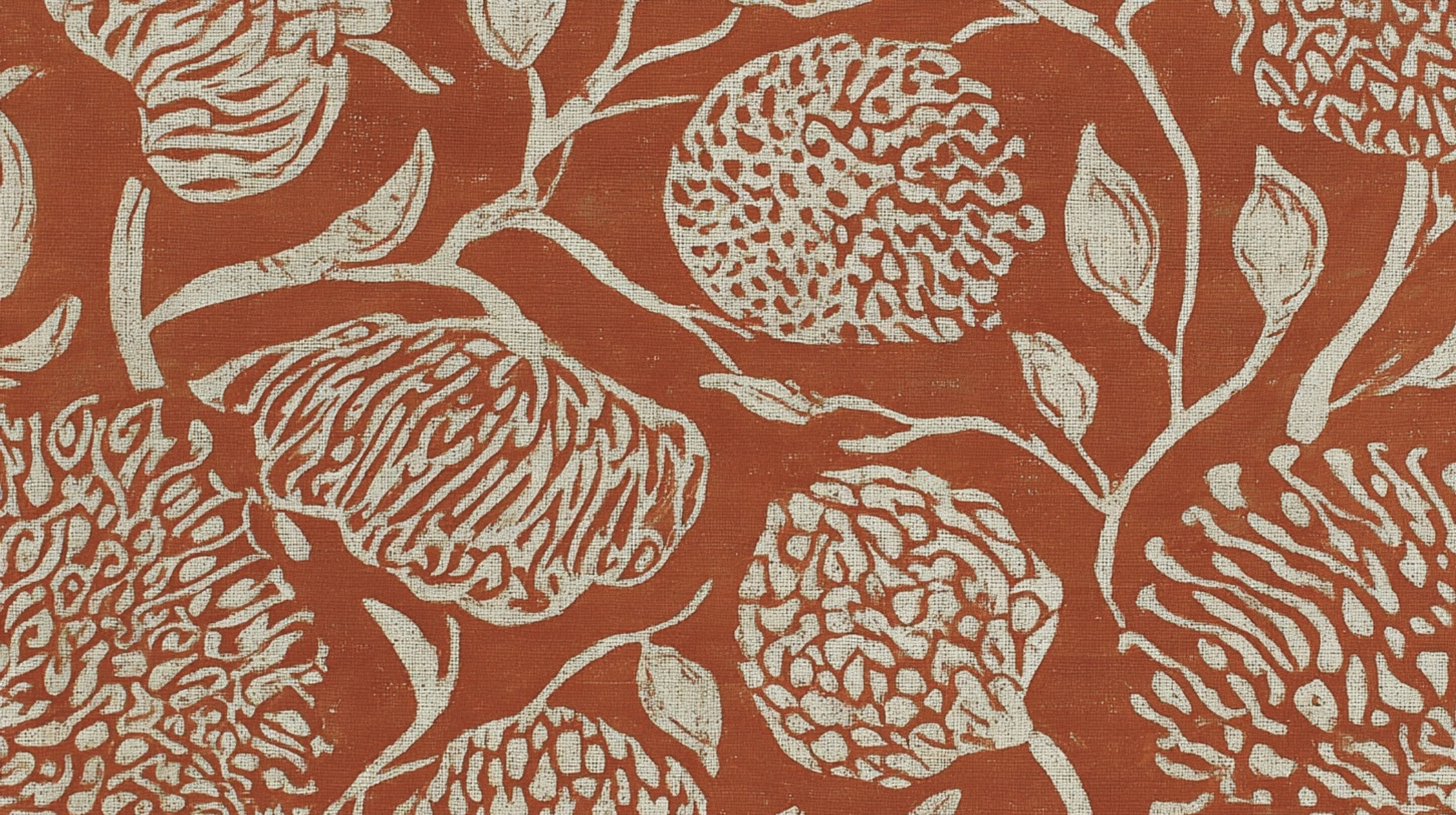 Close-up of a fabric with a red background and a white floral pattern featuring large, stylized flowers and leaves.