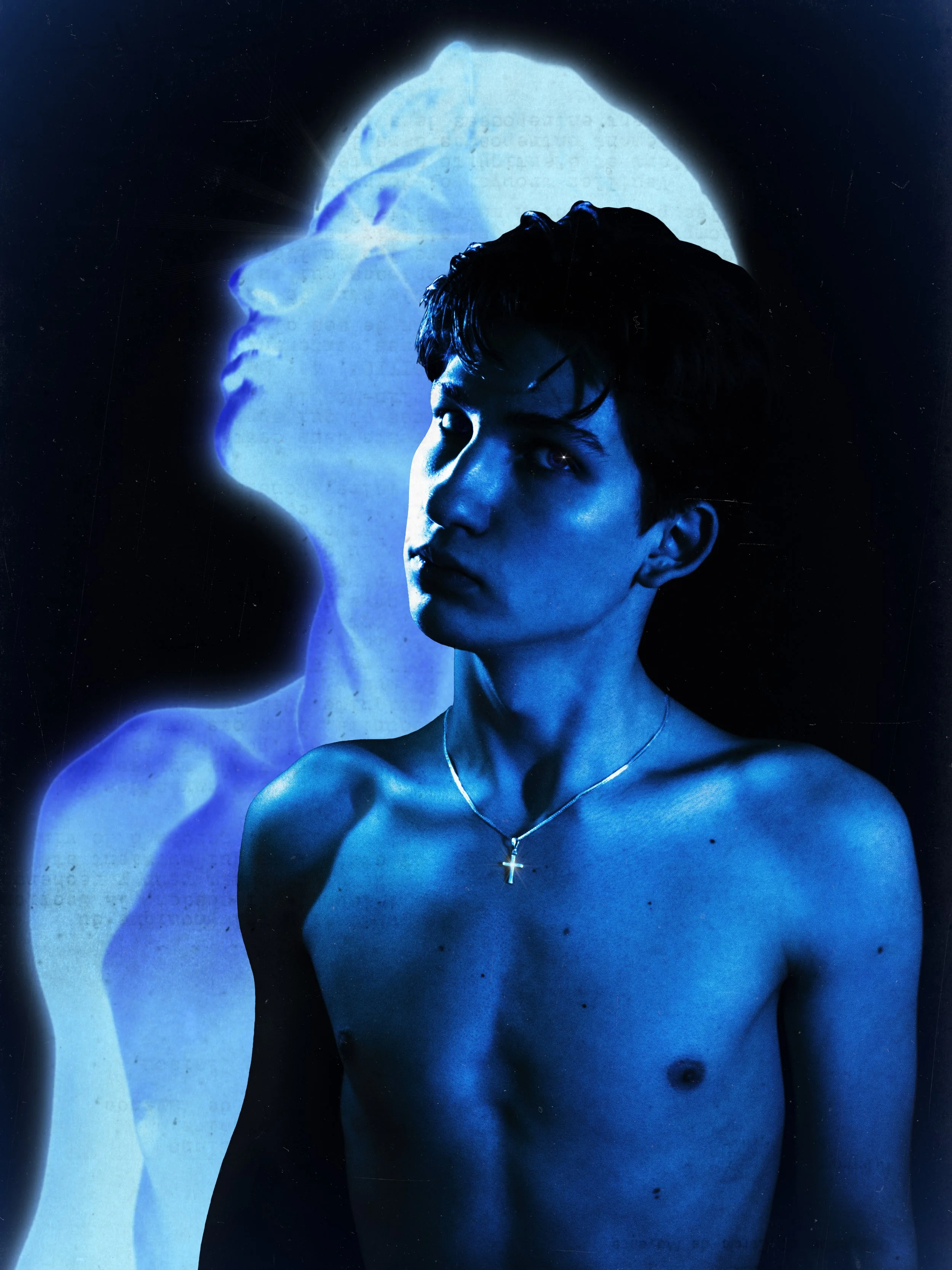 A shirtless young man with dark hair and wearing a cross necklace, looking to the side, with a superimposed, semi-transparent profile of a woman's face in blue tones behind him.