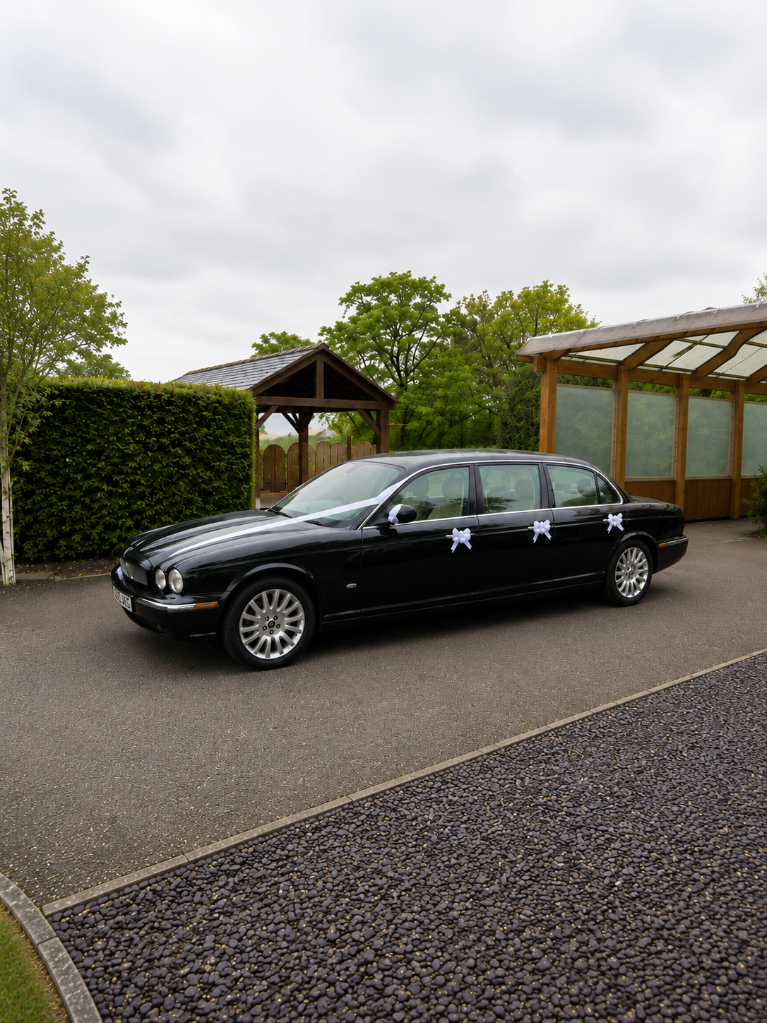 Black Jaguar XJ limousine on a driveway