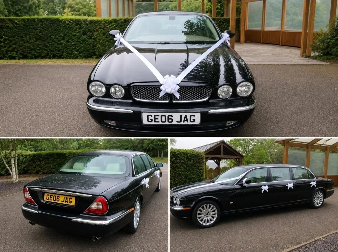 Decorated black Jaguar sedan with white ribbons, possibly for a wedding or celebration, parked outdoors near a wooden structure and green hedges.