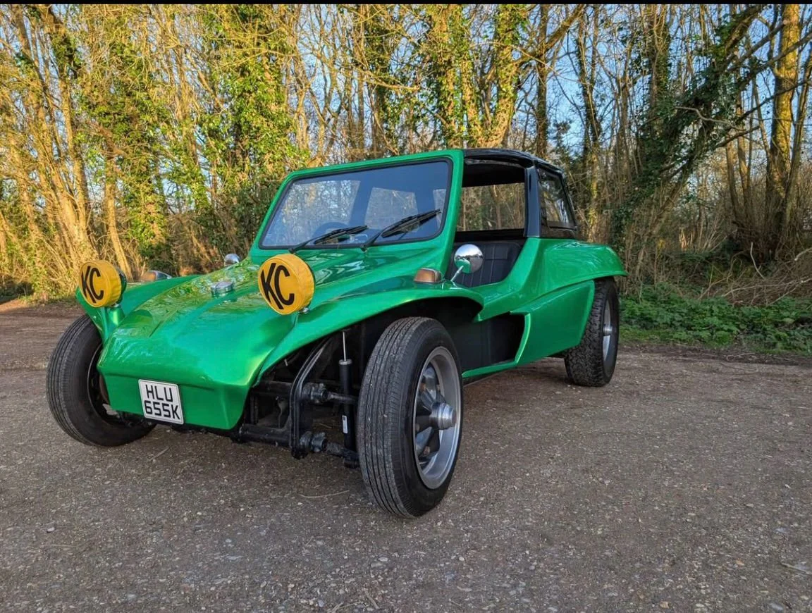 Bright green VW beach buggy parked among trees, available for hire in Torbay