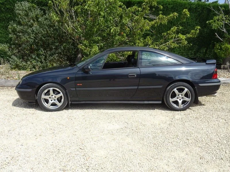 Side view of our black 90s Vauxhall Calibra coupe wedding car